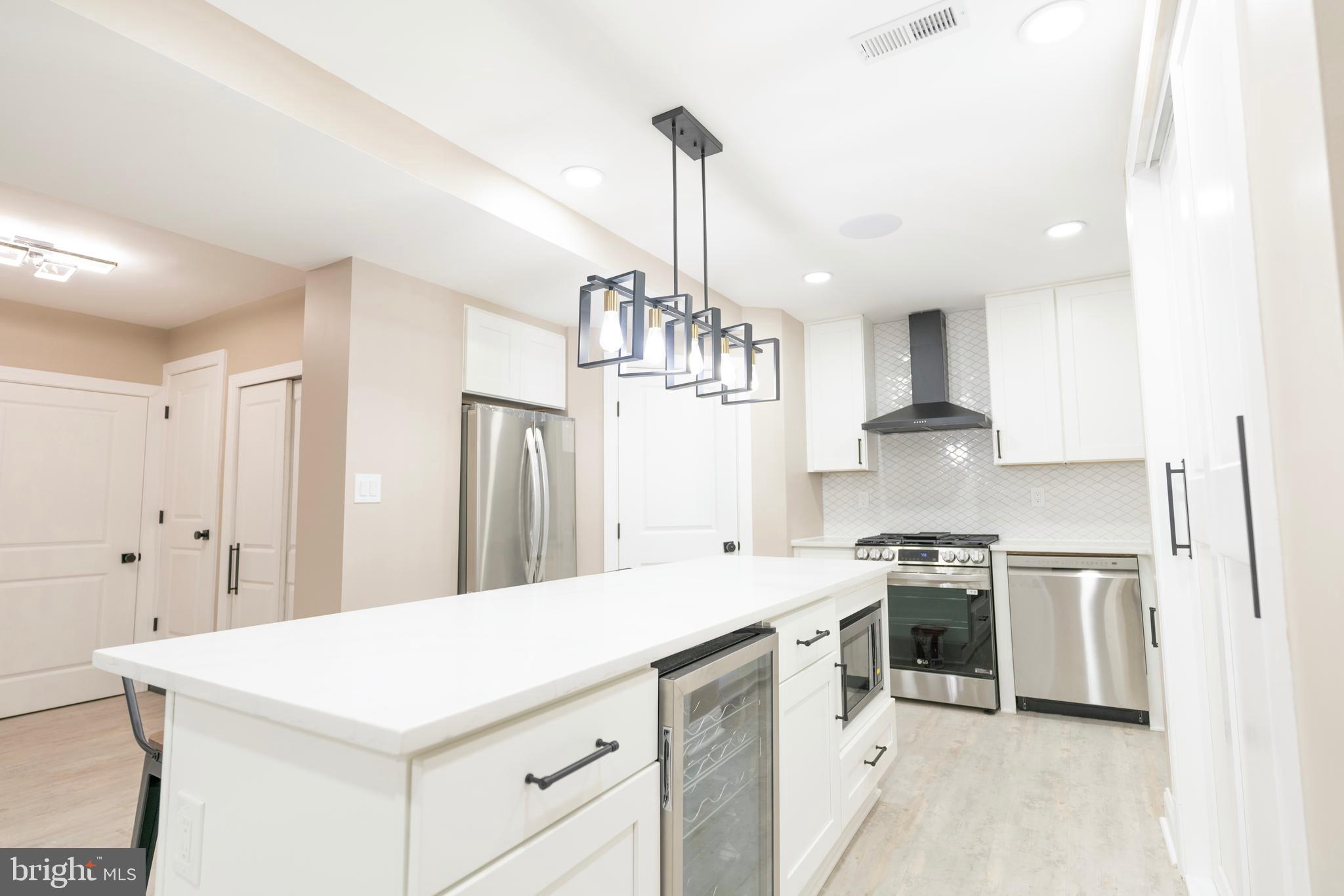 We listened, and now 309 N. Maple Ave is BACK on the market with enhancements you’ll appreciate! This stunning, completely renovated home in the heart of Lansdowne offers timeless charm blended with modern upgrades throughout. The upper level features 4 spacious bedrooms, including a primary suite with an ensuite bathroom, plus an additional full bath. Dual HVAC zones ensure year-round comfort. On the main level, enjoy an open and welcoming flow with a sunroom, an elegant fireplace for added ambiance, and a beautifully updated kitchen complete with a pot filler, wine refrigerator, and stylish finishes. A dedicated office/laundry room adds everyday functionality.
The fully finished in-law suite on the lower level offers a private entrance, 1 bedroom, full kitchen, full bathroom, and its own laundry, perfect for generational living or passive income. Whether you're seeking flexible space or a smart investment, this home is ideal for generational wealth building. Step outside to a private backyard with a charming stoned wall perfect for cozy fire pit nights and a side yard for entertaining. Not to mention the off-street parking for 2 cars in the rear, offering added convenience. With thoughtful updates made based on feedback, this home is better than ever—schedule your showing today!