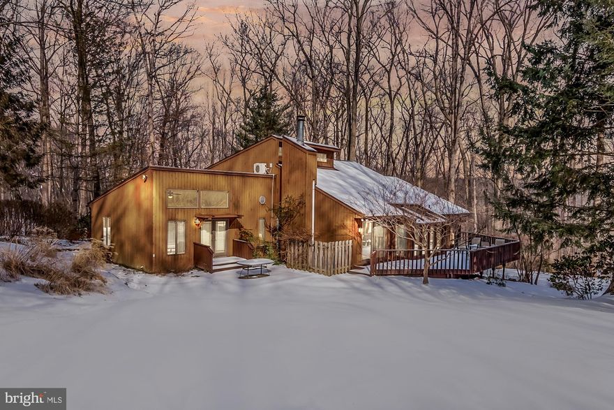 This stunning contemporary home is beautifully situated on a 10+ acre lot in the heart of Monkton. Meticulously landscaped beds frame the home, while the largely wooded lot provides a peaceful respite from the daily hustle and bustle. The main level features a two-story great room that stretches from end to end,  making for the perfect space for both living and entertaining. This wide open space can easily be carved into any configuration that best fits your individual lifestyle. There is plenty of room for a dining room, living room, family room, or whatever kind of living space you might need. In the center of it all and enclosed in glass, is a sunroom that almost seems to bring the outdoors in. It's the perfect place to relax at the end of a long day (your house plants will like it too!). The renovated kitchen features white cabinets, granite countertops, a Sub-zero fridge, a Wolf propane -fueled cooktop, a Bosch dishwasher, and Kitchen-Aid double ovens.  A most charming pocket door leads from the kitchen into a mudroom complete with laundry area and pantry. Just off of the kitchen is a delightful screened porch! Enjoy a cup of coffee or tea and your favorite book in the morning and have dinner among the trees in the evening. This extraordinary home also features two additional doors to the deck that spans the back of the house. Moving on to  the other side of the entry foyer, you will find the first of 5 full bathrooms, as well as the entry to the owners' suite. This suite consists of an anteroom that is currently used as an office. This flexible space could also be an  ideal nursery. If a nursery isn't what you need, then this space would also make a great sitting room, study, craft room or library. As you exit the office into the remainder of the suite, you will find the second full bathroom with a stall shower. The bedroom consists of a vaulted ceiling, a wall of California Closets, and another wall of windows that floods the room with natural light. Even better are the French doors to your very own private patio! The upstairs offers a sweeping view of the great room below. Each of the upstairs bedrooms has its own ensuite bathroom (full bathrooms #3 and #4)! The lower level consists of a finished area that can be used as a rec room, game room, family room, gym, etc. The fifth full bathroom is located off of the finished lower level. In addition, you will also find a large unfinished storage area with a huge cedar-lined closet. If all of this isn't enough, this spectacular property is located within minutes of "downtown" Hereford and all of its amenities (Graul's, library,  post office, pharmacies, banks, seasonal farmer's market, 7-11, a bakery, etc).  And last but not least . . . Hereford Zone Schools!