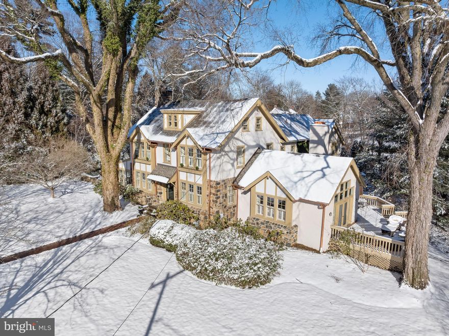 Welcome to 403 Meadowbrook Avenue...affectionately loved by one owner for the last 40 years, and masterfully expanded with numerous additions to create the beauty that it is today!! Quietly nested in the exclusive South Wayne neighborhood known as "Saint Davids", this gracious corner lot property has set a welcoming tone from all entry points for many years. A charming brick walkway leads to the front door and upon entering the Foyer a feeling of warmth captures your soul as natural light bounces off gleaming hardwood floors seamlessly blending formal and informal spaces. The open First Floor plan, rarely found in a house of this age, begins with a lovely Living Room with gas burning fireplace, built-in bookcases, and French doors that lead into a four seasons Sunporch. Walls of windows create a "one with nature" ambiance while providing a perfect private Office oasis with original outside stone walls. Flanking the Foyer is a formal Dining Room that creatively captures the Family Room, while glass pocket doors lead one into the exquisite new Kountry Kraft Kitchen. This gourmet paradise is truly a chef's dream with a large center island featuring  stunning  quarter sewn oak countertop,  dovetail cabinetry, high-end appliances,  leathered quartz countertops, and a Breakfast Area with a built-in banquette overlooking the wrap-around deck. Step down into the large two-story Family Room with soaring wood beamed ceilings, fireplace, and window seats promising to provide years of cherished memories with access to the expansive outside deck. This family-friendly hub of the home is completed by a Mudroom, Power Room and access to the 2-car attached Garage. A gracious staircase leads to the Second Floor where the old and new harmoniously blend and the most glamorous Primary Suite awaits offering a private sanctuary to begin and end your days. Soaring ceilings, window seats, and built-in bookcases are just some of the features that put this suite in a class of its own, but the His and Her separate Primary Baths with walk-in closets are a whole different level of luxury. The Second Floor has 2 additional large Bedrooms connected by a Jack n Jill Bathroom. Additionally, there is a 4th Bedroom with Hall Bath and a convenient Laundry Room. The square footage continues up to the Third Floor where a 5th and 6th Bedroom, and Hall Bath can be found. The magic continues outside as mature landscaping, numerous extensive grass areas, and newly constructed Pergola with flagstone Patio  offer many daily and entertaining options for family and friends. While this exceptional property has grown in size over the last 40 years it has never lost its charming neighborhood presence and is "walkable" to downtown Wayne and train.  Don't miss this gem ...it will make all your dreams come true!! ALL SHOWINGS BEGIN THURSDAY JAN 25th
