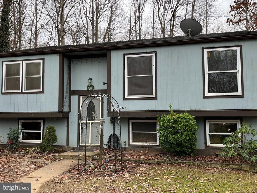 Property to be sold as is. INVESTOR OPPORTUNITY!!!! Price reflects the tender loving care this property needs. It has good strong bones with a FABULOUS  lot and lots of potential. Main level is open with a beautiful sky light, barn decking on the wall and brick wall. Kitchen overlooks dining and living area. There is a deck off the kitchen. The basement has a family room, two bedrooms and storage. There are two parking spaces right in front of the large front yard. The lot over looks the trails and the woods. This one is close to everything, the toll road, shopping and restaurants.