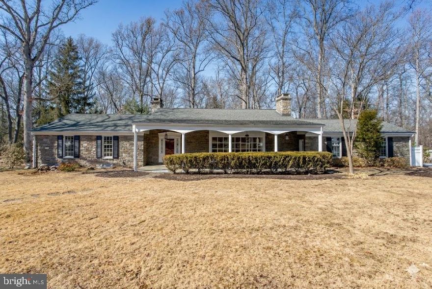 Every once in a while, a truly special custom ranch home comes on the market—one built not just with materials, but with vision, intention, and pride. This is your opportunity to experience craftsmanship, scale, and enduring character rarely found in today’s construction. An expansive covered front patio (48x14) welcomes you home, offering the perfect place to enjoy quiet mornings with coffee or unwind in the evening as the sun settles over your private .95-acre setting in Blythewood, Doylestown Township, Bucks County. Custom-built of timeless stone, this home reflects strength, permanence, and thoughtful design throughout, with room sizes and details that simply cannot be replicated today. Step inside and discover a beautifully upgraded kitchen that serves as the heart of the home—ideal for gathering, entertaining, and creating lasting memories. Enjoy the warmth and charm of three fireplaces, each with its own personality, including one in the private office/study, creating an inspiring and cozy retreat. Beautiful hardwood flooring flows throughout, adding richness, warmth, and classic appeal. The full basement expands the living experience even further, featuring substantial storage and workroom (24x30) and an impressive, finished area (30x40) with a daylight recreation and entertainment space, its own fireplace, and direct walkout access to a stunning fieldstone patio (30x11)—a perfect extension of indoor and outdoor living. Additional highlights include central air, a two-car garage, upgraded appliances and utilities, and refined details that reflect the care and quality invested in this home over time. Homes like this are more than structures - they are sanctuaries. This is a place where comfort, craftsmanship, and setting come together in harmony. You must experience it in person to truly appreciate it. Schedule your private tour today.