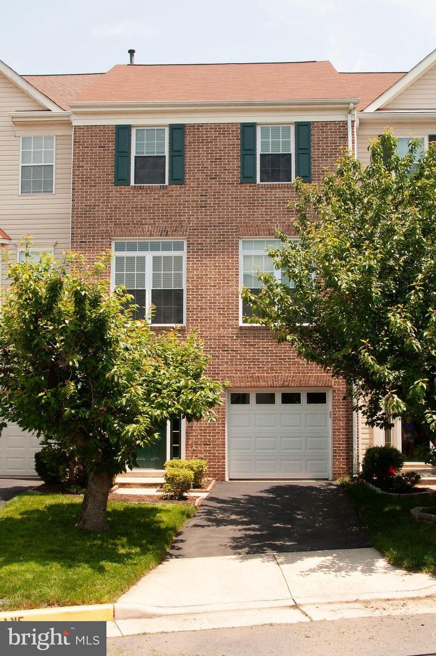 Perfect 3-level 3 bedroom 2/2 bath townhouse with 1-car garage, backing to trees & common area. Lower level rec room has a gas fireplace & walk out leading to a stone patio & fenced backyard. Large open kitchen with room for table and access to rear deck. Hardwood floors throughout (except bedrooms) Lots of light. High 10' ceilings on main level. Cathedral ceilings in master suite with walk-in closet, separate tub and shower and dual vanity. Located very near to neighborhood pool and playground. Approx 1 mile to Silver Line.