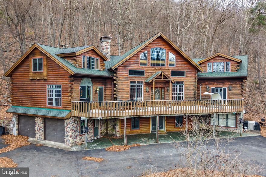 Welcome to this stunning 4-bedroom, 3.5-bath log home perfectly situated on a 1-acre lot adjoining over 100 acres of preserved association land for unmatched privacy and serenity. Located in the sought-after Lake Hauto community—a private, motorboat lake offering beaches, tennis and basketball courts, and year-round community events—this property combines luxury living with the tranquility of nature. Step inside to a jaw-dropping great room featuring cathedral ceilings, floor-to-ceiling windows, and a double-sided custom fireplace. The chef’s kitchen is a dream, showcasing a commercial gas range, center island, and walk-in pantry with laundry. The main-floor primary suite offers convenience and comfort with private access and a spa-like feel. Upstairs, a loft overlooks the great room, flanked by spacious secondary bedrooms, while the lower level is designed for entertainment with a massive wet bar—complete with additional oven, microwave, and dishwasher—plus a private guest suite and full bath. Enjoy stargazing from the private hot tub just off the sunroom, or relax on the expansive decks surrounded by nature. An attached two-car garage and ample parking complete this exceptional property. This is truly a one-of-a-kind retreat offering the best of lake life, privacy, and craftsmanship—schedule your showing today!
