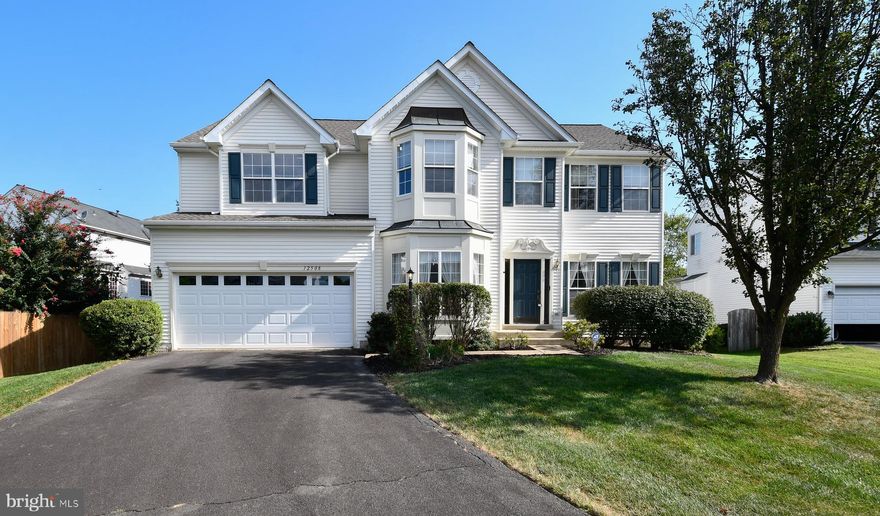 .26 acre cul-de-sac lot in Sheffield Manor; community amenities including an outdoor pool, private lake, community center, party room, sports courts, nature paths, bike trail, playground, and common grounds;  close proximity to I-66, Sudley Manor Drive, Prince William Parkway, and Routes 234, 28, and 29;  spacious 4 bedroom, 2.5 bath home with over 4,100 square feet of living space on 3 finished levels; 2-car garage, custom multi-level deck, fully fenced yard, an open floor plan, high ceilings, built-ins, tons of windows; kitchen features gleaming new “colonial white” granite countertops, extensive 42” cabinetry and quality appliances including a gas range and newer SS refrigerator; large center island; recessed lighting; upgraded custom floor-to-ceiling brick fireplace, stacked windows, and ample space to relax and unwind; library with built-in bookcases; primary bedroom suite boasting a soaring cathedral ceiling with display ledge, lighted ceiling fan, plush carpeting, a walk-in closet, and room for a sitting area; dual-sink vanity, a sumptuous corner soaking tub, and a glass-enclosed shower; 3 additional large bedrooms—each with generous closet space; laundry on bedroom level; walk-up lower level with a spacious recreation room and a versatile media room offers plenty of space for games, media, and exercise, while an unfinished area provides loads of storage space and completes the comfort and convenience of this wonderful home.  2nd fridge in the garage.