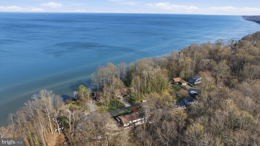 Welcome to a rare offering in the coveted Western Shores community—where breathtaking Chesapeake Bay views, timeless construction, and lifestyle-driven living come together in perfect harmony.

Perched gracefully on a quiet cul-de-sac, this exceptional property delivers the kind of setting that simply cannot be replicated. Wake each morning to shimmering bay views and unwind in the evenings as the sun melts into the horizon—your own private front-row seat to Maryland’s most iconic waterfront backdrop.

Designed with both strength and space in mind, this home features steel beam construction, offering a level of durability and integrity rarely found. Inside, you’ll discover generously sized rooms, multiple indoor living areas, and a seamless flow that makes everyday living as comfortable as it is impressive.

The heart of the home opens to a stunning bay-facing outdoor living area just off the kitchen, creating the perfect setting for entertaining, relaxing, and soaking in the views year-round. Step outside and you’ll find beautifully maintained gardens, expansive parking, and an oversized garage—ideal for car enthusiasts, hobbyists, or anyone in need of exceptional storage and workspace.

The lower level apartment, previously utilized as a rental, provides incredible flexibility—whether for additional income, multigenerational living, or private guest accommodations.

Modern efficiency meets coastal living with upgraded utilities and an owned solar system, helping offset energy costs while enhancing long-term sustainability.

Beyond the property itself, Western Shores offers a lifestyle that is increasingly hard to find. This charming, tucked-away community features a private beach for civic association members, and for those who love a sense of adventure, a walk through the woods to the edge of the property leads to a hidden, secluded shoreline—your own “secret beach.”

With no HOA, yet a strong sense of community, Western Shores blends privacy, character, and convenience with close proximity to everything Southern Maryland has to offer.

Homes in this community are rarely available—come experience why.