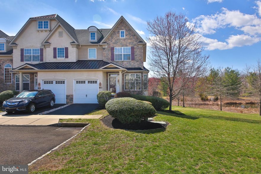 This stunning and elegant corner townhome offers breathtaking views of a serene pond, beautifully landscaped grounds, and access to an in-ground pool. Step inside to a spacious formal living room with gleaming hardwood floors, leading to a sophisticated dining area perfect for entertaining. The well-appointed kitchen boasts ample cabinetry and seamlessly overlooks the inviting family room, where floor-to-ceiling windows flood the space with natural light. Cozy up by the charming fireplace and enjoy the perfect blend of comfort and style in this exceptional home.