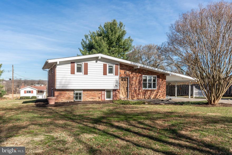 Single family home for town home price!!!! This hidden gem in a NO HOA neighborhood includes many amazing features. Situated on a panoramaic LEVEL .50 acre lot with EXTENSIVE landscaping, , stone driveway and mature trees. Double wide carport ideal for large parties and crab feasts. Separate outbuilding with cement floor, elect and propane hook-up. Many upgrades-Brand new CAC, refrig. and w/d. Large eat in kitchen with granite and ceramic floor. Beautiful hardwood floors throughout (laminated planking in LL family room.) Lots of storage.Woodburning f/p and electric stove. Solatube skylight in hallway. Sun room off family room.Vaulted ceilings.This home is full of charm and comfort. Be in by the holidays! $2K painting allowance to the new buyer ........