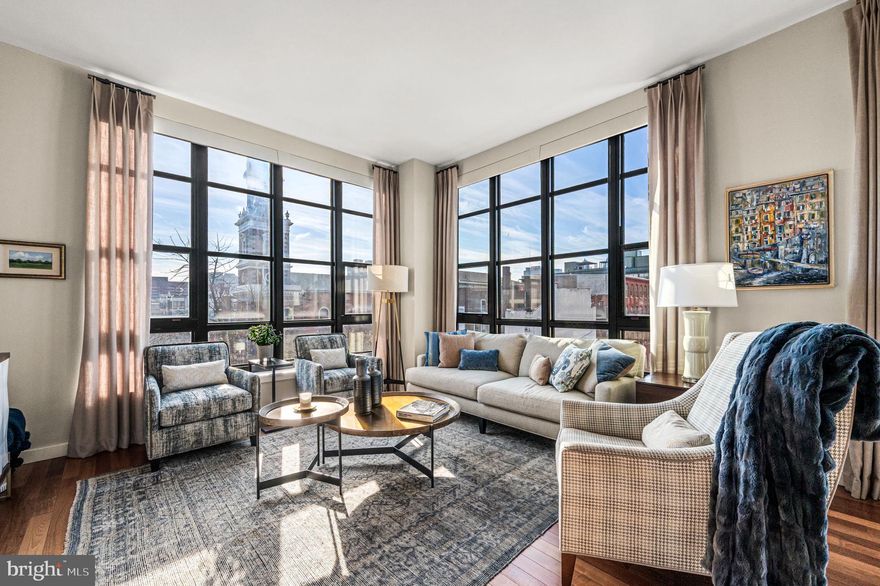 Welcome to York Square, a contemporary mid-rise residence in vibrant Old City, offering deeded parking, a 24-hour doorperson, and refined urban living. This sun filled 2-bedroom, 2-bath corner condominium makes an immediate impression. Floor to ceiling windows, 10-foot ceilings, and an open layout create a bright, expansive feel from the moment you enter. The spacious living and dining area open to a private balcony with charming city views. Hardwood floors, upgraded dining lighting, and a beautiful built in bar with wine refrigerator make the space ideal for both everyday living and entertaining. Custom electric shades add comfort and privacy throughout the main living areas. The open kitchen connects directly to the living space and features quartzite countertops, an upgraded sink and faucet, gas cooking, stainless steel appliances, and a Bosch dishwasher. A breakfast bar provides seating for four. The bedrooms are thoughtfully positioned on opposite sides of the home, offering excellent privacy. The generous primary suite includes custom closets and an en-suite bath with an upgraded Kohler vanity and a bathtub surrounded by floor-to-ceiling tile. The second bedroom, currently used as a den and office, features a full bath, plantation shutters, and upgraded lighting. Additional features include a side-by-side Bosch ventless washer and dryer and a custom coat closet. The residence also includes a full-size storage unit on the same floor, adding everyday convenience. One deeded parking space is included. Residents of York Square enjoy a landscaped courtyard, fitness center, and direct elevator access from the garage to residential floors. The building is pet-friendly, with a dog park located directly behind it. Step outside your door to Old City’s acclaimed restaurants, cafés, historic landmarks, and waterfront destinations. The location offers exceptional convenience, with easy access to the subway, Market Street Station, PATCO, and the Ben Franklin Bridge, as well as I-95, major routes to I-76, Philadelphia International Airport, and endless shopping, dining, and entertainment options.