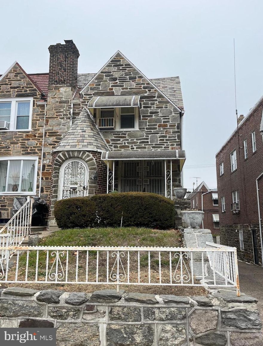 Stately home in Overbrook.  Walking distance to Overbrook High School on an impressive and well kept street in a beautiful section of Philadelphia.  This home, with its timeless stone facade, fine architectural details and great location is a unique opportunity to renovate into a glorious home in a fantastic location.  This home, sporting a stately stone turret for an entrance, provides the extra light and additional doorways only an end provides, along  finely crafted hardwood floor awaiting your renovations and finishing touches. this home has a 1 & 1/2 car garage, accessible from the basement, providing a home for your car!  The home has an ensuite making two full baths on the 2nd floor along with a small powder room in the basement. No HOA!  Enjoy the efficiency and value of natural gas heating.  This home qualifies for renovation financing and potentially grant money for repairs.