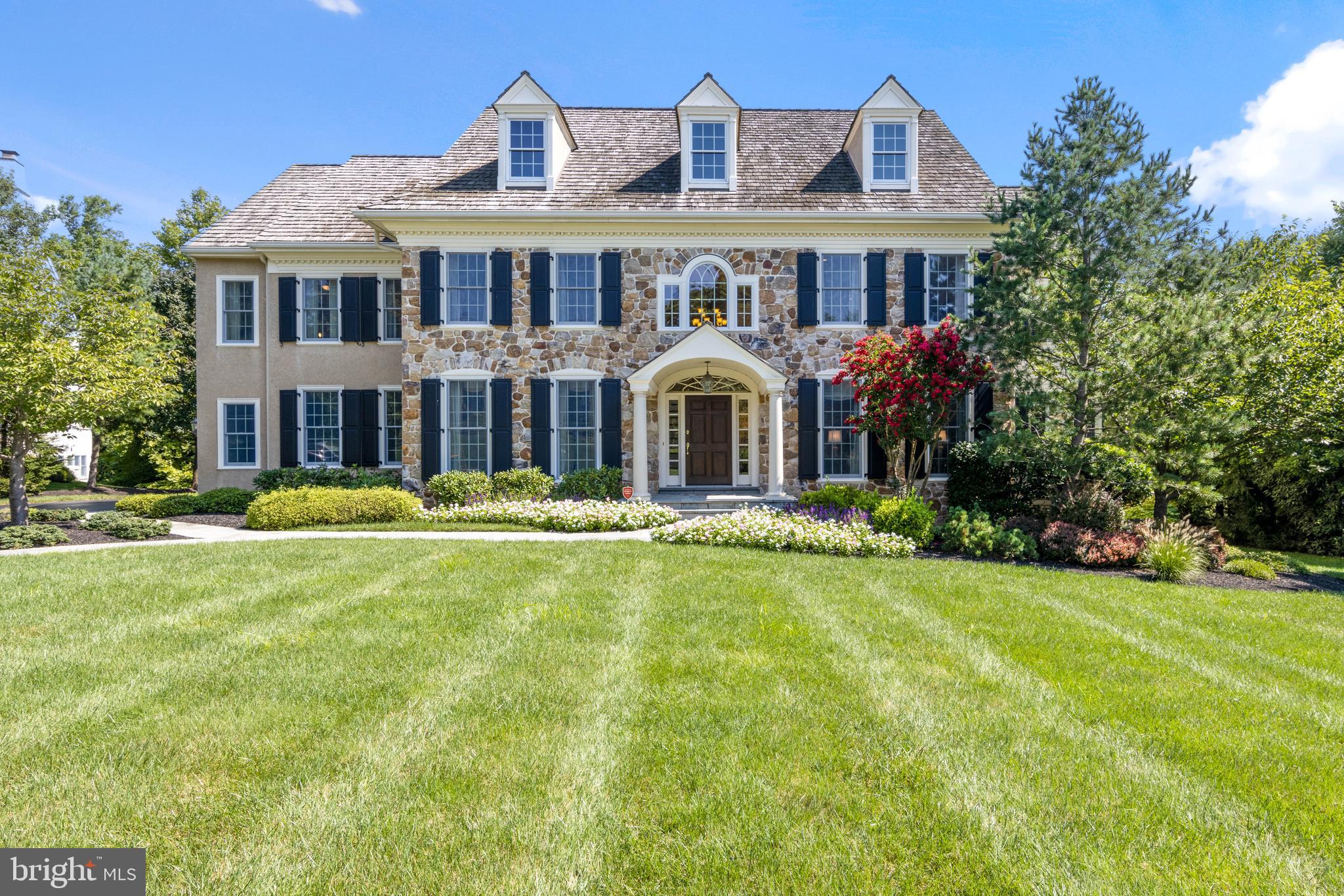 Majestically sitting on a premier lot in the estate section of Berwyn is this spectacular home in distinguished Saybrook. First time offered by original owners in this distinguished enclave of 22 homes, the stunning property backs onto woods and offers unparalleled design and privacy. Enjoy entertaining al fresco on your choice of expansive deck, stone patio or the stone-walled fire pit and patio overlooking lovely grounds with mature landscaping. Masterfully built of superior detail, this expanded Elm model has five-bedroom features a center hall grand foyer and open floor plan, gorgeous millwork and striking formal living room. The expanded dining room seats multiple guests for family entertaining or for holiday dinners; an attached butler's pantry provides ease of service. The stunning library transitions to a separate reading room/ sunroom--his and hers offices in these changing times. Sixteen-foot ceilings in the family room and a floor-to-ceiling stone fireplace complement the wall of windows viewing the professional landscaping opening to the gourmet epicurean Kountry Kraft kitchen with huge island. A chef's dream of Sub-Zero and Wolf appliances this kitchen flows to the sundrenched morning room overlooking the gorgeous grounds. The second floor is equally remarkable with master suite featuring tray ceiling and recently completely updated high end master bath. There are four additional generously proportioned bedrooms. The finished lower level walk-out family room has a fabulous bar, pool room, workout room and other recreational areas to use at your discretion. Walkout to the spectacular grounds offering another level of living surrounded by lush specimen plantings. This stunning home was built by the premier Main Line builder Bentley Homes and is located close to the train, all amenities, all major highways and the fabulous restaurants on the Main Line. VIRTUAL TOUR or press video tour above