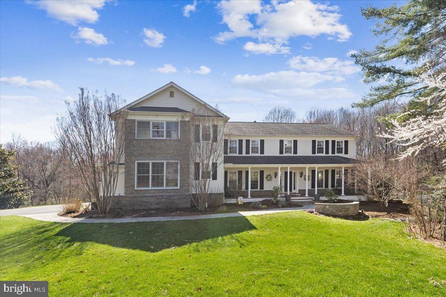 Welcome to this exceptional 3-car garage Colonial—a true Gem—in the highly sought-after Foxvale community of Oakton. Situated on a private 0.5-acre cul-de-sac lot with additional open space backing to a pond and Wayland Street Park, this move-in ready home offers over 6,000 square feet of beautifully finished living space, 4 bedrooms, and 3.5 baths. Meticulously maintained for more than three decades, this home reflects true pride of ownership, highlighted by two significant expansions and extensive remodels totaling over $900,000. All renovations were professionally designed by a top-rated architect, ensuring visual integration and optimal functionality complemented by high-end finishes and refined details throughout.
A charming covered front porch provides a warm and inviting entry. The main level has an open flow, designed for both everyday living and entertaining, featuring a spacious family room with gas fireplace, custom cabinetry, granite hearth and surround, and lighted glass shelving. A bright windowed-wall   sunroom with skylights and ceiling fans offers views of the wooded parkland and opens to the deck. The main level also features a stunning formal living room with bay window, dining room, updated powder room, and a thoughtfully designed mudroom with built-ins and utility sink. A convenient wet bar with cherry cabinetry, sink, and refrigerator further enhances the home’s entertaining appeal.
The gourmet kitchen is a standout, showcasing a large center island (7' x 4') with a 6-burner Viking gas cooktop and downdraft, granite countertops, custom lighting, and heated tile flooring for year-round comfort. Additional highlights include GE Monogram stainless steel appliances (double convection ovens, dishwasher, and 4-door French refrigerator), a barista station, built-in desk area, window bench seating with storage, and under-cabinet lighting throughout. A well-appointed pantry includes a secondary refrigerator, large sink, and custom Elfa storage system.
Upstairs, the expansive primary suite offers a private sitting area with double-sided gas fireplace, custom built-ins, window bench seating, two large walk-in closets with Elfa systems, and a vaulted ceiling. The luxurious ensuite bath features a jetted soaking tub, rain shower with river rock flooring, dual vanities with granite counters, private water closet, and heated tile floors for a true spa-like experience.
The upper level also includes three additional spacious bedrooms (one with a hidden bonus room), an updated hall bath, and a large laundry room with built-in sorting system, folding area, sink, and extensive cabinetry.
The walk-out lower level is designed for recreation and relaxation, featuring a professionally designed home theater with seating for seven, projector, screen, and surround sound. A large recreation area, wet bar with cabinetry and refrigerator, full bath, glass-enclosed fitness room, cedar-lined closets, and additional storage spaces complete this level. Heated flooring extends throughout the lower-level living areas, adding exceptional comfort.
Outdoor living is equally impressive, with a two-level deck featuring Zuri flooring, multiple access points, shade sails, and irrigation systems on deck, lawn and gardens. The covered brick patio below includes a storage room. The property also boasts a fully equipped greenhouse, pollinator garden, berry trellis, and a small orchard with a variety of fruit trees.
The highly-sought Oakton Swim and Racquet Club is nearby; membership is available to convey. 
This remarkable Gem offers a rare combination of luxury, privacy, extensive custom upgrades, and thoughtful design in a premier Oakton location with NO HOA.