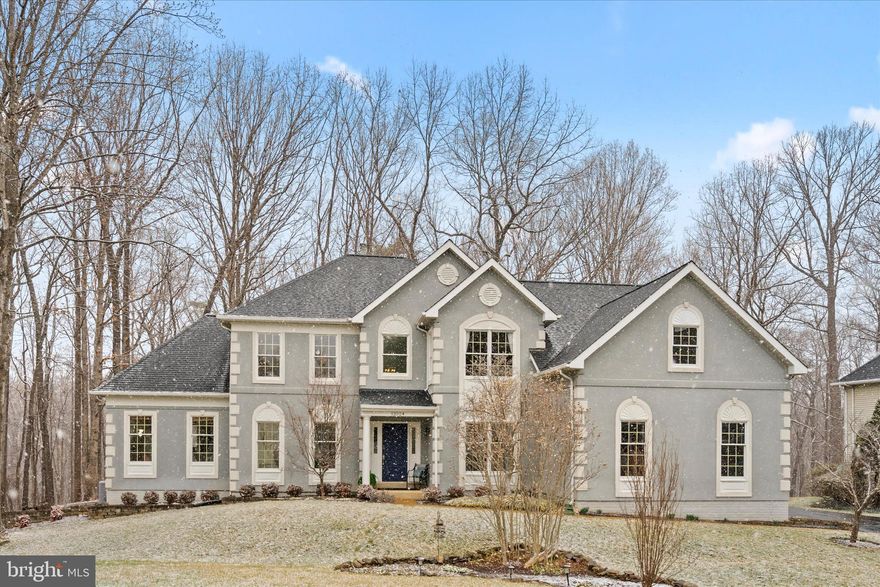 Welcome home to this updated Colonial set on approximately half an acre, the largest lot in the development with a rare three-car garage and exceptional backyard privacy. A two-story foyer and hardwood flooring introduce the main level, featuring a private office with custom built-ins and a main-level bedroom suite with sitting area and full bath, ideal for guests or multigenerational living. Formal living and dining rooms offer traditional entertaining spaces, while the gourmet kitchen with BlueStar and Bosch appliances opens to a spacious family room with fireplace and high ceilings. 
Upstairs, the primary suite includes a sitting area, expansive walk-in closet, and spa-style bath with steam shower, a stand alone tub, along with three additional bedrooms and a full hall bath. The unfinished lower level provides extensive storage, a rough-in for a full bath, offering flexibility for future customization.
The private backyard retreat features a patio, small pond, and mature tree-lined backdrop, a rare combination of usable space and seclusion within the community. Recent updates include a whole-house vacuum system (2021), EV charger (conveys), new electrical panel, recently replaced stucco, and a newly paved asphalt driveway. Roof is 2019, Main HVAC 2012, water heater 2016. With its premium lot, rare three-car garage, extensive updates, and private outdoor setting, this is a standout opportunity within the community. Experience the space, privacy, and quality for yourself.