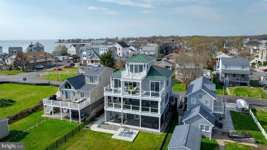 WOW!! Welcome to 2811 Bay Drive in Miller's Island! This stunning home offers 4 levels of breathtaking waterfront views of the Chesapeake Bay, a 130ft pier with boat slip, a 16,000 lb boat lift, elevator, 2-car garage, and high-end finishes throughout!
The entry-level offers a half bathroom and access to your screened-in patio which is the perfect spot to take in the incredible waterfront views. The 2nd level consists of two true primary suites with unbelievable bay views and deck access from the bedroom, a spacious 3rd bedroom, and a laundry room. The 3rd level features an open floor plan with hardwood floors throughout, an updated kitchen with stainless steel appliances and quartz countertops, a large living room with gorgeous views, a formal dining room, full bathroom, bar area, and a spiral staircase leading to the 4th level. The 4th level offers a large bonus room (possible 4th bedroom) that opens to the top-level deck with panoramic Bay views.
Enjoy entertaining in your large yard with 50ft of water frontage, or relax on one of your 3 decks/screened-in rooms. The extended 130ft pier, complete with a brand new 16,000 lb boat lift, water and electric makes this an absolute boater's dream! This is a true waterfront experience!  
This tight-knit waterfront community offers the perfect balance of activity and tranquility. Whether you're casting a line, crabbing off the pier, or simply watching the sun rise over the Chesapeake Bay with a cup of coffee, the pace here is yours to set. For those who love to get out and explore, cruise over to Row Boat Willies, Bowleys Quarters, Hart Miller Island, or join in on community traditions.  When peace and quiet calls, you'll find relaxation with stunning open water views, gentle bay breezes, and the natural beauty of nearby North Point State Park, a 1,310-acre waterfront preserve perfect for hiking, unwinding, and reconnecting with nature. Miller's Island isn't just a place to live, it's a lifestyle!