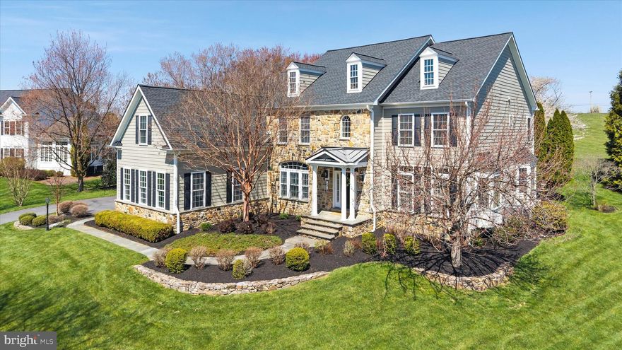 Set on a beautifully landscaped 1-acre lot in Olmsted, 5 Traylor Dr in West Chester, Pocopson Township offers the style, scale, and level of finish expected in a turnkey luxury home within the Unionville-Chadds Ford School District. A new roof and striking stone-and-James Hardie exterior create timeless curb appeal.

Inside, hardwood flooring, detailed custom millwork, 9+ foot ceilings, and a flowing open layout create a polished yet comfortable living experience. The renovated kitchen is both stylish and highly functional, serving as the centerpiece of the home with a large center island, butler’s pantry, and chef-grade stainless steel appliances, including a Thermador 6-burner gas range and oven, KitchenAid warming drawer, and Sub-Zero refrigerator.

The Great Room is ideal for entertaining, featuring a floor-to-ceiling stone fireplace and a wall of windows overlooking the spectacular rear patio. A standout feature of the floor plan is the presence of two dedicated office spaces, offering exceptional flexibility for working from home, study, creative pursuits, or a quiet retreat.

Upstairs, the renovated primary bath with heated flooring adds a fresh, elevated feel to the private owner’s suite, which also features a coffered ceiling and enormous walk-in closet. Each additional bedroom includes its own private en-suite bath and walk-in closet, providing comfort and privacy throughout.

The finished walk-out lower level, complete with a full bath, expands the living space with room for media, recreation, fitness, guests, or entertaining. Outside, the beautifully hardscaped slate-and-stone rear patio is framed by mature landscaping, creating a refined outdoor setting for entertaining, relaxing by the fire pit, or gathering with guests. There is also space for a pool, if desired.

Enjoy the neighborhood walking trail or explore the adjacent acreage of the Brandywine Red Clay Alliance. Complete with a 3-car garage and a sought-after Brandywine Valley location, this is a rare opportunity to enjoy updated, move-in-ready living in the Unionville-Chadds Ford area.