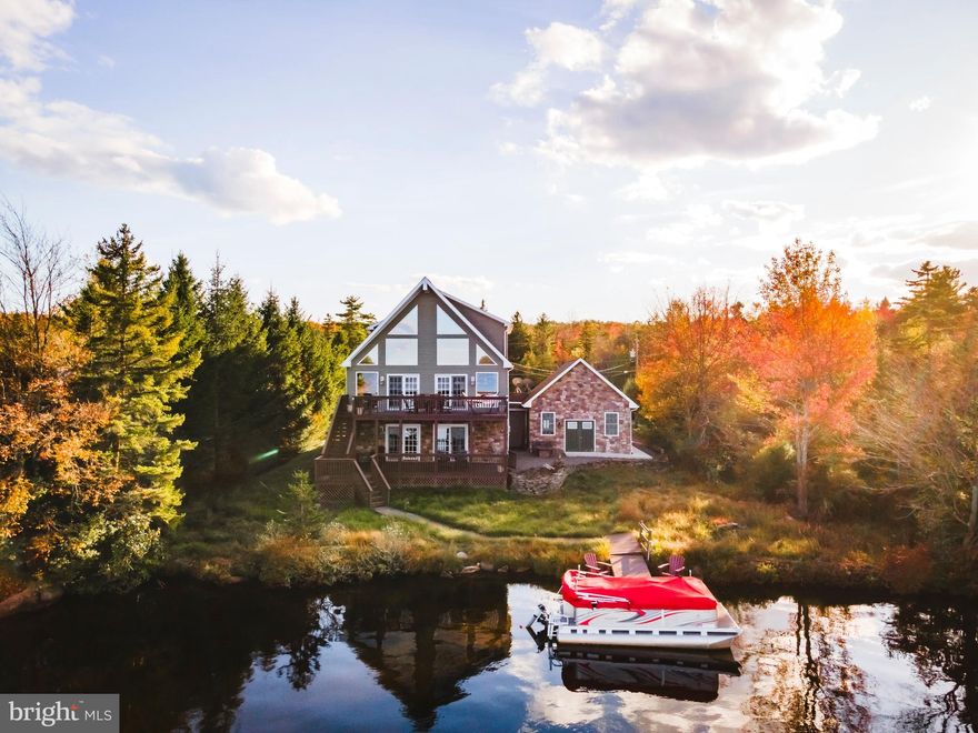Discover this exquisite custom-built lakefront residence, a harmonious blend of stone and vinyl, spanning three stories. Nestled on a serene street, this property boasts nearly three-quarters of an acre for your enjoyment. Wake up to the mesmerizing sunrise on one of the most coveted lakefront lots in Towamensing. 3-4 bedrooms and 3.5 bathrooms, this home offers abundant space for your comfort and relaxation. Meticulously designed, it features not one, but two stone fireplaces, two convenient laundry rooms, and dual master bedrooms .The chef-inspired kitchen is an epicurean's delight, featuring granite countertops, handcrafted maple cabinetry, a generously sized island. On the second level, you'll find hardwood flooring.The expansive windows in the DR & LR frame breathtaking vistas of the lake, allowing you to immerse yourself in the natural beauty of the surroundings. LL featuring a grand family/game room, complete with a cozy fireplace and an impressive 16-foot bar and kitchen area, perfect for hosting guests. Step out onto the upper and lower decks to entertain or simply soak in the unparalleled beauty of the lake. A convenient walkway leads to a private dock, offering an idyllic spot for fishing and swimming. This home is genuinely one-of-a-kind and a pleasure to showcase. Whether you seek a full-time residence, a vacation sanctuary, or a lucrative rental property, opportunities are limitless. Don't let this chance slip away to own this extraordinary lakeside retreat.