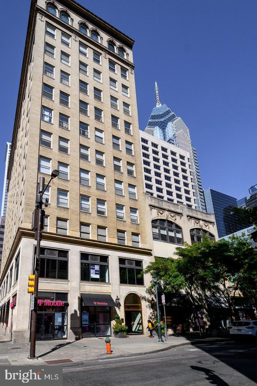 An impeccable 2004 rehab of this 1900 office building brilliantly transformed the space into contemporary dwellings with luxurious high end modern finishes. Here, imaginative and stylish loft living mingles open space with private rooms. With a sleek and sophisticated design by acclaimed architect Neil Sandvold of Sandvold Blanca, gorgeous hardwood floors and spacious rooms are stand-out features of this magnificent 4300+ sf home occupying the entire floor and featuring three bedrooms/three baths. A 360 degree view of Center City is yours, with spectacular natural light pouring in through huge windows by day. Elegant window shades provide ample privacy by night. Enter this grand home directly from the elevator – a private entrance to your Center City sanctuary. The entry area offers extensive closet space and an elegant powder room that includes a hidden shower. The entry takes you to an enormous living room/dining room area. Expansive common areas flow seamlessly into each other. A private study is separated by gracious sliding frosted-glass barn doors, providing both light and privacy. This spacious room offers built-in floor to ceiling cupboards, and cabinetry on two sides. The home features a sleek and professional chef’s kitchen, equipped with all stainless steel appliances. Amenities include a dishwasher, an 8-burner Wolfe range with dual oven, and a Sub-Zero refrigerator. A partial wall of the eat-in kitchen allows the cook to join in the dining room conversation, while hiding the thoroughly modern kitchen counters and its contents. Moving northward in this block-long apartment takes you to a lovely TV/entertainment room separated from the main common area with a pair of sliding frosted-glass barn doors. Across the hallway is a series of large built-in closets, leading to an expansive wine “cellar” with two full size Sub-Zero wine refrigerators surrounded by racks on both sides. With a capacity of 800 bottles, even the most ardent of oenophiles will find a spot for all their possessions. The luxurious master bedroom suite is essentially an entire wing to itself, and can be closed off for complete privacy. Features include a sitting room, dressing room, fabulous walk-in custom built out closets, and a bath with heated floors, private commode, steam shower, and double vanity. The second and third bedrooms share an en-suite bath with soaking tub, shower, and frosted glass privacy doors. Even the laundry room is spacious, with its own window view. In addition, there is a large storage/utility room nearby. Boasting a prime location, this pet-friendly 10 story building contains 20 units. Rittenhouse Square is just one block away, while right across the street is one of the city’s most acclaimed gourmet shops. The surrounding walkable neighborhoods contain some of the finest theaters, shops, and restaurants in the city. Convenient location provides easy access to 30th Street Station, the Airport, and other forms of transport. From its days as an office building, 1737 Chestnut Street retains such original lobby features as a huge brass door, brass banisters, and a vintage wall-mounted mailbox.