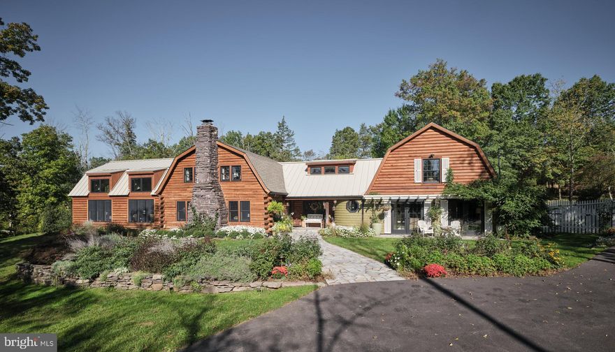 Raspberry Hill, a Luxury Log Lodge Compound – A Perfect Blend of Rustic Elegance and Sophistication
Nestled within a breathtaking natural landscape, this extraordinary log lodge compound embodies the perfect blend of rustic charm and sophisticated design. A true masterpiece, this unique property offers an unparalleled living experience in a serene, private setting.
As you enter, you’re greeted by a ​pleasant living room, with exposed timber beams, that exudes warmth and character, featuring a stunning river rock fireplace as its centerpiece, perfect for cozy evenings or gathering with loved ones. Step into the expansive great room, where soaring vaulted ceilings  and oversized windows allow natural light to pour in, creating a sense of openness and connection to the surrounding landscape.​ A striking fireplace provide​s an element of coziness and sophistication, creating an inviting atmosphere for both relaxation and entertainment.
The gourmet kitchen is a culinary dream, equipped with top-of-the-line appliances, custom cabinetry, and ample counter space to satisfy even the most discerning chef. A formal dining room, also featuring gorgeous exposed timber beams, and a wood stove offers an elegant setting for family dinners and special occasions, with views of the surrounding landscape that add to the charm of every meal.
The primary suite on the main level offers a true retreat, featuring a spa-like en suite bathroom with luxurious finishes, large closets, and picturesque views of the surrounding wilderness. Two additional bedrooms on the upper level provide ample space for family or guests, each thoughtfully designed to offer comfort and privacy. A second level studio, accessed by a  staircase on the back of the home, has a private balcony. Inside you'll discover a living/work space,  the fourth bedroom, and a full bath offering versatility—whether used as a guest house, office, or creative space.
For those who love to entertain, the outdoor living space is truly exceptional. Step outside to find a stunning outdoor kitchen and a sparkling pool, perfect for summer days spent lounging in the sun or hosting lively gatherings under the stars. The expansive patio and outdoor seating areas offer an idyllic setting to enjoy the natural beauty of the property.
This log lodge compound is a rare find—a harmonious blend of rustic elegance and modern sophistication, offering a lifestyle of unparalleled comfort and beauty. Whether you're seeking a permanent residence or a luxurious weekend retreat, this property is sure to exceed your expectations.
Schedule a private tour today and experience the unique charm and luxury of this exceptional estate.