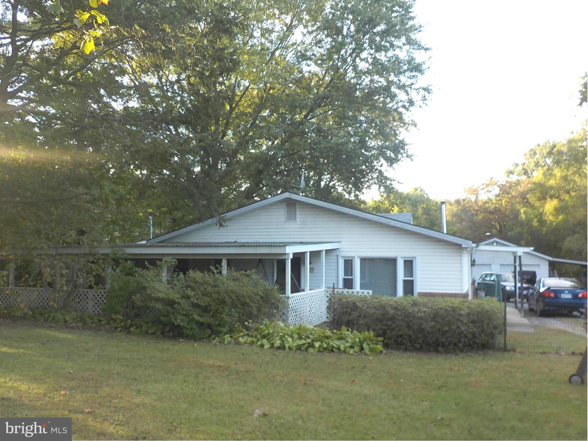 HUGE PRICE ADJUSTMENT! Two parcels convey for a total lot size of .77 acres. One floor living on a large level fenced lot, feel like you are living in the country with easy access to all amenities. Over sized garage, carport and outbuilding on premises. Home features a covered porch, large eat in kitchen area, pellet stove. bedroom with loft area & a luxurious jet tub. Separate laundry/mud room.