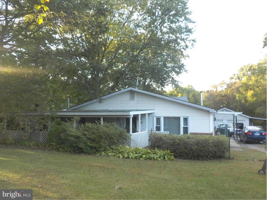 HUGE PRICE ADJUSTMENT!  Two parcels convey for a total lot size of .77 acres.  One floor living on a large level fenced lot, feel like you are living in the country with easy access to all amenities. Over sized garage, carport and outbuilding on premises. Home features a covered porch, large eat in kitchen area, pellet stove. bedroom with loft area & a luxurious jet tub. Separate laundry/mud room.