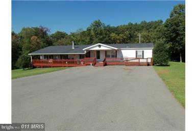REDUCED! Travel down a dirt road & see what awaits at the end of a blacktop drive! The nicest, largest manufactured homes this Realtor has ever seen. 2240' on perm foundation, HW floors, fresh paint, 10'X80' covered porches, Master suite with separate sitting room, walk-in closet, garden tub, shower stall, granite counters, wired out buildings, 4 bedroom, 2 bath, nice yards, with woods.