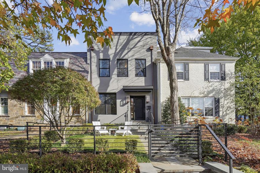 Experience the perfect blend of contemporary design and luxurious comfort in this nearly-new Burleith residence. Offering 5 en-suite bedrooms and over 3,600 square feet of impeccably designed living space across four levels, this home is both a modern sanctuary and a showcase of thoughtful functionality.

Set above the street with a fenced front garden, the home offers privacy and elevated views of the lush, green neighborhood. Gas lanterns frame the front entry, inviting you into a space boasting soaring ceilings, abundant natural light, and wide-plank light oak flooring throughout. At the heart of the home is the gourmet kitchen—a chef’s dream—complete with a breakfast bar island clad in Carrara quartz, Thermador appliances, a coffee bar, and endless cabinetry and countertops. The front living room features a sleek gas fireplace, while the family room at the rear boasts custom built-ins and opens to a covered deck with a built-in gas grill, perfect for indoor-outdoor entertaining. Premium features such as a Sonos sound system, WiFi routers on every level, and a transferable alarm system enhance the home’s effortless functionality.

Every bedroom is a private retreat with its own stylish bath. The primary suite is a true haven, offering a spa-like wet room with a soaking tub and multi-function shower behind a glass wall, a floating double vanity, a sprawling walk-in closet, and a private rear deck. The fully finished lower level adds versatility with its high ceilings, wet bar, spacious bedroom, and private entrance, making it ideal for an in-law suite, gym, or home theater. 

Outdoor living spaces abound, including private decks on each level and a rare front-facing rooftop deck nestled among the trees. This unique design ensures privacy and captures unrivaled views not available from rear-facing decks. Off-street parking completes the convenience of this exceptional home.  

The location could not be more ideal, just steps from vibrant amenities in both Burleith and Georgetown—groceries, parks, shops, and dining. Top public and private schools are also a stone’s throw away including WIS, Hyde-Addison, and Hardy. This residence offers an urban lifestyle at its most sophisticated.