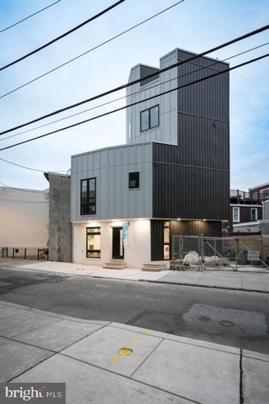 Welcome to 437 Memphis, one of the most intricate, unique, and modern new construction homes in red-hot Fishtown. Featuring 4 bedrooms, 3 baths, a finished basement, 2 outdoor decks, a private rear yard, abundant natural light from massive windows, exquisite finishes, and a quiet block in the heart of the neighborhood—this property truly has it all!

Enter the first floor and enjoy striking architectural angles, a high-end kitchen with solid wood soft-close custom cabinets, under-cabinet lighting, quartz countertops, and premium appliances. The open kitchen and living area flow seamlessly to the private rear yard, perfect for grilling and pets. The second floor offers 2 spacious bedrooms with ample closets, a laundry area, and a full bath with ceramic tile and a floating vanity.

The third and fourth floors feature a loft-style primary suite with incredible natural light, a luxurious bath with ceramic tile, a floating vanity, and a rainfall showerhead. The finished basement adds valuable living space, a fourth bedroom, and another full bath.

Additional highlights include two fiberglass roof decks, a high-velocity HVAC system, luxury vinyl flooring throughout, floating stairs with steel handrails, solid wood doors, pine trim, and dimmable lighting. Situated on one of Fishtown’s best and most private blocks, this home offers easy walkability to top restaurants like Kalaya, Suraya, and Mulherin’s.

A truly one-of-a-kind home with unmatched design, layout, and craftsmanship—plus a 10-year tax abatement. Vacant and easy to show—schedule your appointment today!