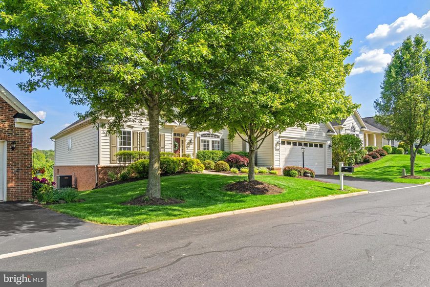 This beautiful home is perfect for discerning buyers looking for main level living.  Expansive, open concept floor plan has something for everyone.   Large kitchen with bar seating, breakfast nook, sun room and huge great room with gas fireplace.  The library/home office is nicely tucked away from the hub of the home making for quiet work space.  The master suite has large walk-in closet, tray ceiling and luxury bathroom with soaking tub and private water closet.  Two additional bedrooms are located at the other side of this home.  Enjoy the screened porch with views of nothing but woodlands and wildlife.  Lower level has plenty of natural lighting, rough in for additional bathroom and walkout.  Enjoy simple living in this over 55 community with walking trails and lots of amenities!