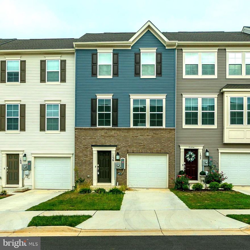 Welcome to this stunning resale townhome built in 2024, offering 3 bedrooms, 2 full bathrooms, and 2 half bathrooms across three thoughtfully designed levels. Upon entry, the lower level features a convenient half bath, a single car garage, and a spacious recreation room at the rear of the home—perfect for a home office, playroom, or second living space. The main level boasts luxury vinyl plank flooring throughout, creating a seamless flow. The gourmet kitchen is a true centerpiece with a large island, white cabinetry with custom pulls, granite countertops, stainless steel appliances, a custom tile backsplash, and large pantry.  The kitchen offers space for a dining table or the option to use the island with barstools for casual meals.  Off the kitchen is a low-maintenance composite deck, perfect for relaxing evenings or entertaining guests.  A spacious family room at the front of the home provides plenty of space to host gatherings and relax with everyone. 
Upstairs, you’ll find three generously sized bedrooms and two full bathrooms. The primary suite includes a walk-in closet with a custom organizer and an ensuite bath featuring dual sinks and a tiled shower with a seat. Two secondary bedrooms share a full hall bath, and the laundry is conveniently located on the upper level.  The current owner has added valuable upgrades, including custom cabinet pulls, a designer kitchen backsplash, window blinds throughout, framed vanity mirrors in the full bathrooms, a custom closet organizer in the primary suite, and a saltless water softener to extend the life of appliances.  This move-in ready home combines modern finishes, thoughtful upgrades, and a functional layout in a highly desirable location.  The neighborhood offers fantastic amenities, including a community swimming pool, playground, and scenic walking trails.