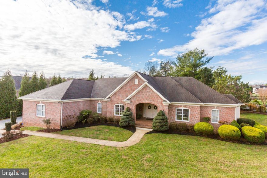 Extraordinary & expansive, this custom built, all-brick stately rancher embodies class and beauty.  Impeccable landscaping graces a grand covered entry with double doors that enter the home.  The foyer is open to a huge living room with tray ceiling and panoramic views of the yard and porch.  An open floorplan allows for easy entertaining - a spacious butler pantry connects the dining room to the massive gourmet kitchen.  An oversized granite island & breakfast bar is the focal point of the kitchen, accompanied by all brand-new stainless steel appliances.  Vaulted ceilings and skylights create a dramatic atmosphere and tie in the breakfast room and family room with gas fireplace and premier in-wall speaker system.  Walls of windows and slider to porch let the sunlight simply pour in.  The private wing offers a primary bedroom with tray ceiling, access to patio and private full bath, three additional bedrooms and two more full baths.  The separate office space is perfect for working from home or a virtual learning environment.  Decorative appointments include: crown & chair moldings, 6" baseboards, custom paint, built-in cabinetry and hardwood flooring.  The full, unfinished lower level is ready and waiting to be turned into the space of your dreams!  Outdoor living features a large ceramic tiled patio with ceramic heater, built-in grill, oversized three-car attached garage, gas powered generator, front and back landscape lighting  & professionally landscaped, lush lot!