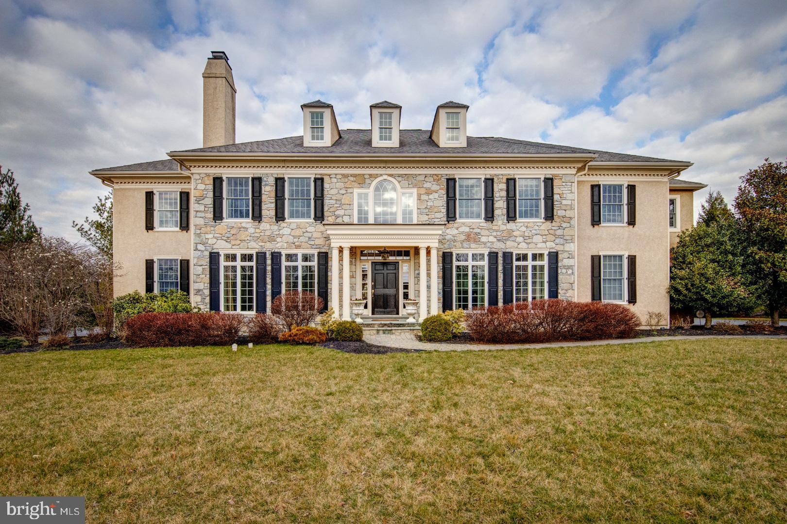Magnificent colonial manor home built by Bentley Builders with over 5,600 square feet of exceptional living space situated on a beautiful level lot with mature landscaping on a cul de sac in the community of Whitegate. The exterior features include a beautiful grey mica stone front, two expansive EP Henry patios, firepit, outstanding stone hot tub with waterfall cascading into a fabulous pool with water features, three-car side load garage, and a beautiful backdrop of mature plantings and extensive landscaping. The interior of this elegant home features a large living room with fireplace, formal dining room, top-of-the-line custom kitchen with every imaginable amenity, a light-filled breakfast room, a bright two-story family room with stone fireplace, a private study and an adjacent sunroom with glass French doors to the study and family room. This open floorplan allows for active family living and great entertainment space. The Second Floor features an impressive Master Suite with dressing/sitting room, custom walk-in his and her closets, sumptuous master bathroom with oversized whirlpool soaking tub and large glass enclosed shower and four additional ensuite bedrooms with walk-in custom closets. Hardwood floors throughout the first floor, 10 ceilings, high hat lighting throughout and numerous picture windows make this home airy and bright. This central location is just minutes from King of Prussia and Wayne for local shopping and dining and is within close proximity to all major roadways for commuting to Center City, the airport and the 422 and 202 corporate corridors.