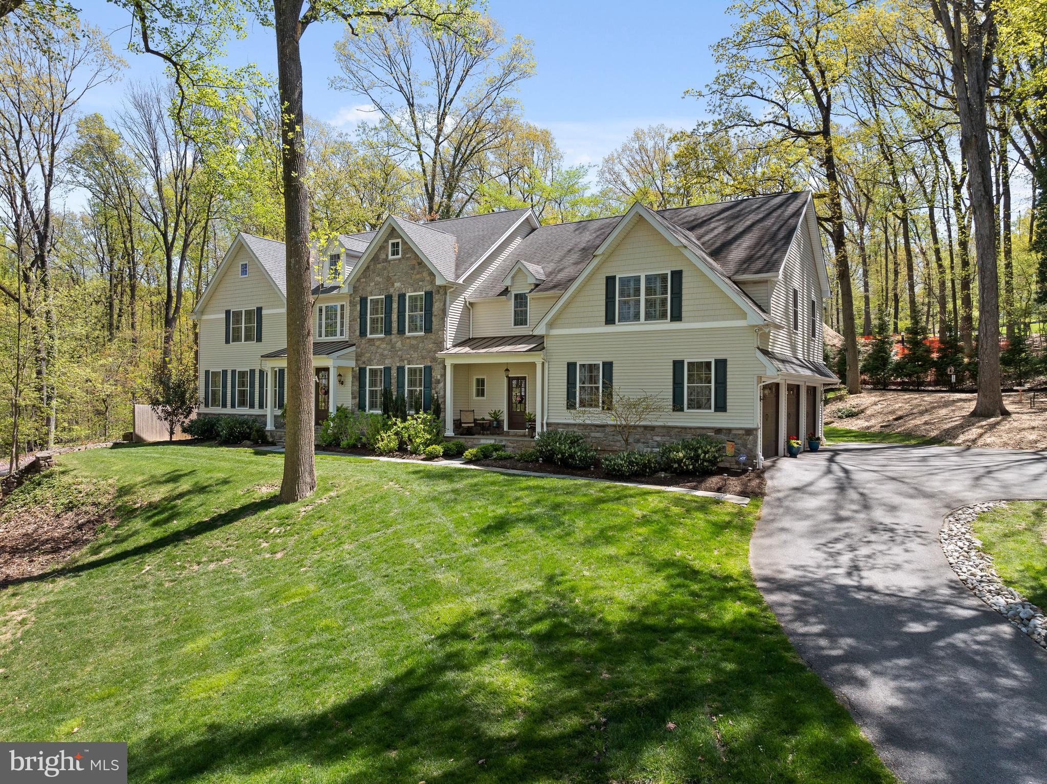 Crafted by the esteemed Renehan Building Group just five years ago, this residence in the prestigious Tredyffrin-Easttown School District embodies the epitome of quality construction, a highly desirable floor plan and luxury finishes. As you step inside, a two-story foyer adorned with hardwood flooring sets the tone. To the right, an expansive dining room awaits, enhanced with crown molding, wainscoting, and a convenient wine bar. Through French doors to the left, a home office space beckons, complete with built-in shelving and abundant natural light. The heart of this home lies in the open-plan kitchen, breakfast area, and family room. The kitchen, a haven for culinary enthusiasts, showcases quartz countertops, white cabinetry, stainless steel appliances, and a center island. Connecting the kitchen and family room, the breakfast room, with its lovely views of the rear grounds, provides a comfortable space for meals. The family room space is elevated by a tray ceiling, a gas fireplace, and sliding glass doors that open onto the rear patio, adding to its appeal. Nearby, a second powder room, walk-in pantry, and mudroom, lead to the three-car garage. Ascend to the second floor to discover the expansive primary bedroom suite, boasting a sitting area, luxurious ensuite bathroom, and spacious walk-in closet. Four additional generously proportioned bedrooms, two sharing a Jack-and-Jill bathroom and two with ensuite baths, are ideal for family members and guests. The second floor also houses a convenient laundry room. The lower level is beautifully finished, offering versatile space for entertainment and recreation, including a den, home theater room, and full bathroom. Outside, relish the tranquility of a private wooded lot from the stone terrace, perfect for al fresco gatherings or serene relaxation.
Enjoy music using the in-home entertainment system while relaxing on the main floor area and on the terrace. Positioned conveniently near Rt. 202, downtown Wayne, and the bustling Main Line community, this extraordinary residence presents an optimal balance of tranquility and accessibility to amenities.