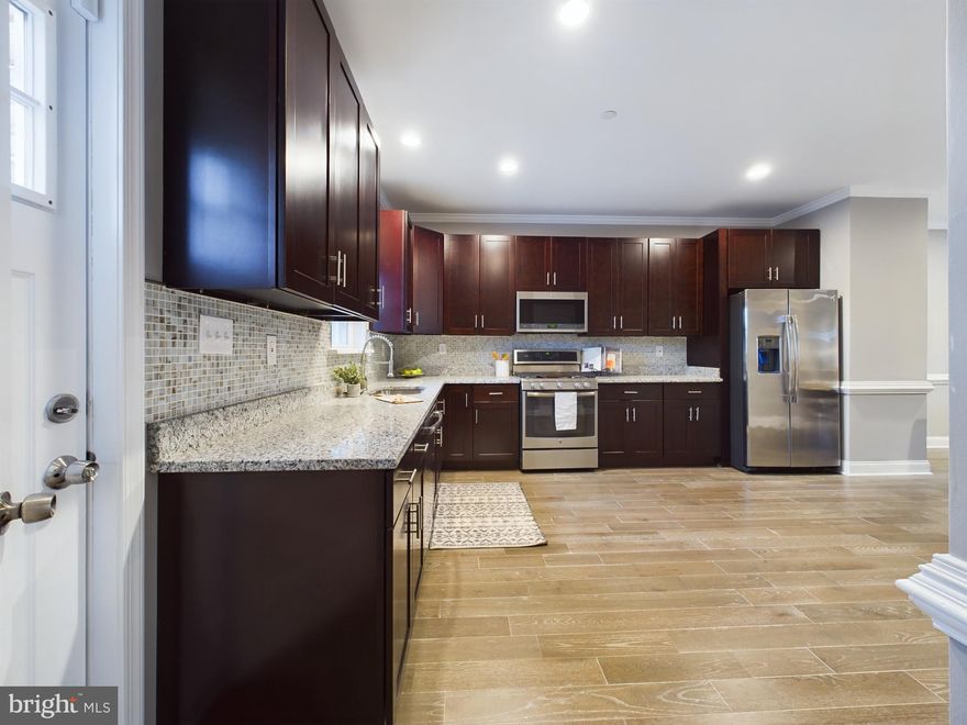 Introducing to the market, 1517 E. Chase Street, meticulously curated and available exclusively through Realty ONE Group Excellence. This exquisite New Construction Townhome offers a unique opportunity to indulge in four levels of opulent living. ONE of three Newly Constructed Homes!

Upon entering the main level, prepare to be captivated by the expansive open floor plan, epitomizing an ultra-modern lifestyle. Immerse yourself in the luxury of hardwood floors, complemented by a chic half bath and a kitchen adorned with a four-piece Profile appliance package and granite counters. This culinary haven extends seamlessly to a deck, perfect for both relaxation and entertainment.

Ascend to the second level, where two private bedrooms await, each appointed with ceiling fans, walk-in closets, and recessed lighting. Embrace the epitome of comfort, as each bedroom boasts its own private full bathroom. The second level also houses a dedicated laundry area equipped with front-loading washer and dryer.

The third level is a sanctuary of indulgence, featuring a primary bedroom with a full bath, walk-in closet, plush carpeting, and ambient recessed lighting. A thoughtfully designed lounge area opens onto a private deck, offering panoramic views of the city skyline.

The lower level invites you into an expansive open floor plan, complete with another half bath, recessed lighting, and sleek ceramic tile. This space seamlessly transitions to a private patio, providing an exclusive retreat for relaxation.

Parking is effortlessly accommodated with the inclusion of a detached garage, ensuring both convenience and security. Seize the opportunity to make this newly constructed home yours, strategically situated in close proximity to shopping, schools, restaurants, and entertainment. Enjoy swift access to Harbor East, Canton, Inner Harbor, and local venues, making every aspect of urban living effortlessly accessible. Elevate your lifestyle with this extraordinary residence that effortlessly combines luxury, functionality, and a coveted location.