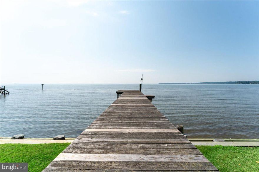 Nestled in the sleepy fishing town of Deale, Maryland, this beautiful waterfront home offers stunning expansive views of the Chesapeake Bay. With six spacious bedrooms, three baths, and over 3,400 square feet, it’s a perfect blend of comfort and coastal charm. The front yard is ideal for games of cornhole, enjoying a fire pit or launching your kayak or paddleboard for a sunrise adventure, and you can try your hand at digging for clams near your own pier.

With a cup of coffee in your hand watch  the charter boats slowly head out of Rockhold Creek in the mornings for a day of rock fishing, and later on enjoy the local boutiques, antique shops, and award-winning seafood restaurants with tiki bars for a laid-back, vacation vibe. Being just 45 minutes from Washington, D.C., this home is not only a serene retreat but also a convenient primary residence or second home.

Whether you leave it as-is or transform it into the dream retreat you’ve been imagining, the potential here is incredible. To help spark your vision, we enlisted an architect to reimagine the layout and exterior—creating a fresh concept you’re welcome to use or customize to fit your own style. Ask your agent for a copy of the plans if you’re interested!