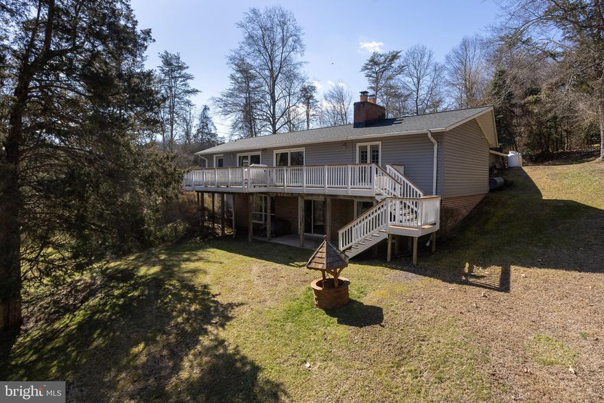 Welcome to 17300 Evna Road, a 4BR/3BA raised rancher with 2,943 sqft,  with a two-car garage on nearly 3.5 acres sitting on the cusp of the Gunpowder State Park in Parkton; this immaculately well-kept and updated home is truly one of a kind! 
Within, one will find an expansive foyer leading to both the dining and living room (also known as the great room), along with access to the kitchen on one wing of the home and access to the first-floor bedrooms located on the other wing of the house, including the primary suite. 
Starting in the kitchen, one will find an updated kitchen with Corian countertops, a double wall oven, plenty of cabinet and countertop space, S.S appliances, a built-in microwave, a lovely backsplash, a breakfast bar, and a ceramic floor with a captivating inlay. Remember the breakfast nook, which has plenty of space for dining. 
The great room, with expansive space, can display an entire dining room set and a living room set, with the ability to still feel spacious. With cherry hardwood floors and near floor-to-ceiling windows, including Pella sliding doors, to the expansive deck, this room has exquisite views of the Gunpowder State Park across the street and access to the oversized deck to enjoy nature from the deck in the summer or inside during the winter. With crown molding throughout this room and a marble fireplace hearth, this room has timeless features. Further down the hallway is a lovely updated hall bath with a glass shower door, updated flooring, and vanity.
The first bedroom, presently used as a home office, includes hardwoods, a large closet, and plenty of lighting. Onto the primary suite, with two large closets, a lovely updated bathroom, hardwoods within the bedroom, and access to the large deck. 
Onto the basement, one will find two large bedrooms with hardwood flooring and plenty of natural light. Along with a completely updated full bathroom and plentiful closet and storage space, the basement has a game area with the capability for a pool table, a separate television/entertainment nook, and a highly efficient pellet stove to keep the basement and home warm. Remember the unfinished area, great for storage. 
On the exterior, one will find an oversized deck with trex decking, built-in benches, and a spacious stairway to the yard. A Guardian generator with three backup propane tanks ensures the house will run in case of an outage.