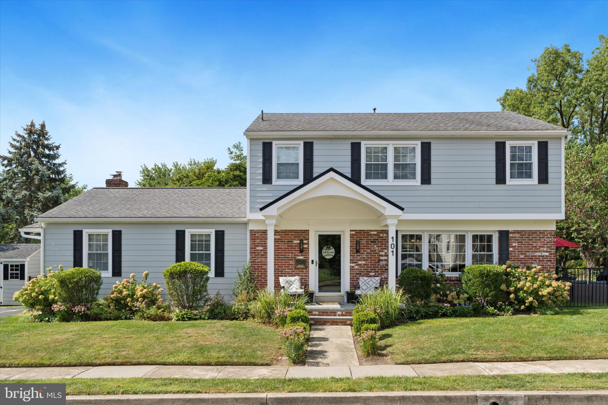 Welcome to 101 Rockland Road—a beautifully maintained Colonial in the heart of Havertown, PA, where timeless charm meets modern updates. Offering more than 2,342 square feet of living space, this home features 4 bedrooms and 2.5 bathrooms designed for both comfort and convenience. The property greets you with a covered front porch framed by a perennial garden—an inviting spot to enjoy peaceful mornings or relaxing evenings outdoors. Inside, a thoughtful floor plan provides the perfect balance for quiet nights at home or entertaining family and friends. On the main level, you’ll find a generous dining room, an inviting eat-in kitchen, and a multi-functional laundry and pantry area. The expansive family room, centered around a cozy gas fireplace, is ideal for gatherings of all sizes. A first-floor office with custom built-ins and French doors to the patio offers a bright and versatile space—perfect for working from home or unwinding with a good book. A convenient half bath completes the first floor. The finished basement expands your living space with a playroom, gym, workshop, and large storage area, all protected by a comprehensive waterproofing system. Upstairs, the serene primary suite includes a private en-suite bath, complemented by three additional bedrooms and a full hall bath. Each bedroom features custom storage systems for maximum organization. Two fully floored attics add even more storage flexibility. Recent upgrades provide peace of mind for years to come, including a new roof, siding, and gutters (2023), whole-home foam insulation (2023), HVAC system, tankless water heater, and an upgraded electrical panel. Step outside to a fenced-in yard with a bluestone patio—the perfect setting for al fresco dining or summer gatherings. The home’s location is unmatched, just moments from the Haverford Township Community Rec Center, Paddock Park, the YMCA, and a variety of local restaurants and shops. Don’t miss the chance to own this special home in one of Havertown’s most desirable neighborhoods.