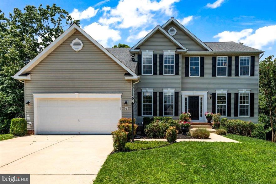 This lovely home is  located at the end of a cul-de-sac , in amenity filled Leeland Station.  The lot is oversized and backs to planned forever wild.   The outside is beautifully landscaped with large roses,  a contemporary color palette of gray siding with black shutters and new light fixtures.  Upon entering the front door take a moment to look up at the light filled 2 story foyer with landing overlook, updated Repose Gray paint and light fixtures.  Located at the front of the home is a private office with French doors and living room with oversized crown molding.   Hardwood floors cover the 1st floor and are new to the living and dining rooms.   The dining room has crown and chair rail moldings, and several windows to view the treed lot.  The large kitchen provides abundance of cabinets and counter/inland space and stainless steel appliances.  The gas stove and  built in microwave are new!  Off the kitchen is a large, recently stained deck.  The kitchen is open to an eating area and large family room.  The owner had additional windows installed to allow wonderful views and natural light.  The gas fireplace has a tile surround and natural oak mantel.   New carpet is on the open staircase and throughout the upper level.   The large owner's retreat  has a vaulted ceiling,  sitting area and two large closets.   The owner's bath has dual vanities, water closet,  oversized soaking tub and new fixtures.   The three additional bedrooms have plenty of room and walk in closets.  The main bath's best features are the long vanity with double sinks and tile floors.   The walkout basement is huge.    Plumbing  for another full bath and an egress window offers the ability to add another bedroom suite and room to expand.  The sliding door lets in  amazing light and provides access to a patio and the tree lined backyard.   While in the area, check out all Leeland Station has to offer:  miles of walking trails, including to the VRE and elementary school, the Bel Aire Clubhouse, large community pool, several playgrounds and sport courts.  The community is also known for it's numerous social activities.