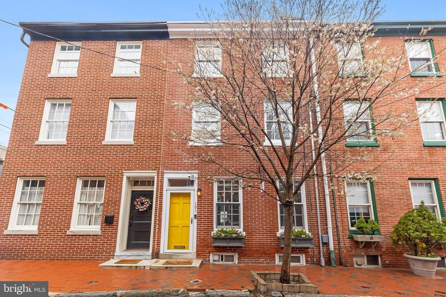 This stunning 3-bedroom, 2.5-bath townhome in the heart of Queen Village checks every box- character, functionality, privacy, and beautifully curated upgrades. Fully renovated from top to bottom in 2018 and lovingly maintained by its current owners, this home impresses from the moment you enter. Step through the vestibule into an open-concept living and dining area, where original pine floors- restored to their former glory- add warmth and charm. A spacious coat closet and designated space for shoes create a practical, welcoming entry. Continue into the thoughtfully designed kitchen, featuring butcher block countertops, open shelving, premium appliances, and a cozy breakfast bar. A tucked-away pantry provides added storage, and just beyond, a private brick patio awaits. Upstairs, the entire second floor is dedicated to the primary suite. Designed with intention and functionality, this level features  a fireplace flanked by 2 storage closets, a walk-through wardrobe tailored for two, and a spa-like bathroom with radiant heated floors, a zero-threshold shower, linear drain, and abundant natural light. On the third floor, you'll find two spacious bedrooms with generous closet space and a bright hall bath. The partially finished basement adds even more flexibility, offering space for a playroom, media area, home gym, or additional storage. Located in the sought-after Meredith School Catchment, with easy access to I-95, shopping, and some of the city’s best dining spots- this home truly has it all.