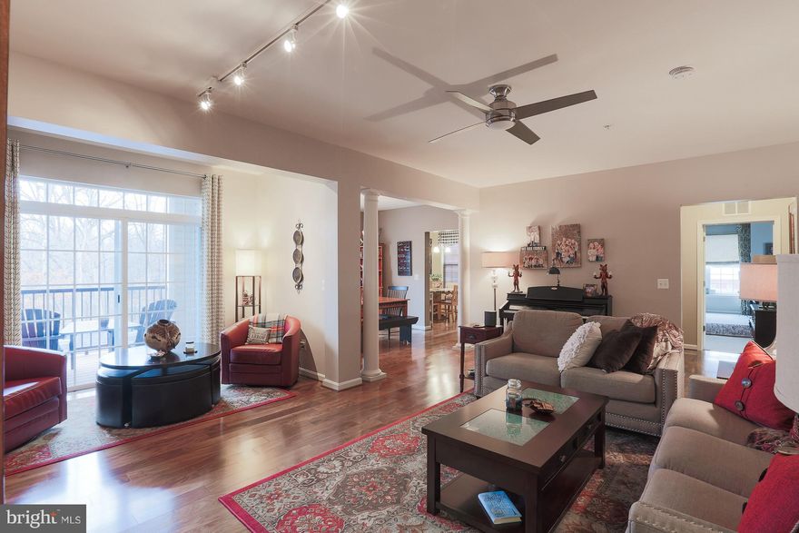 WOW FACTOR GALORE!  2YR YOUNG PRISTINE CONDO BOASTS 1963 SQ FT WITH $30,000 CUSTOM UPGRADES;  CORNER UNIT FEATURES SPACIOUS MASTER SUITE;  SPECTACULAR LIBRARY;  SUNNY EAT IN GOURMET KITCHEN; STUNNING, PRIVATE GUEST ROOM/BATH;  ALL CUSTOM CHESAPEAKE CLOSETS INCLUDING SEPARATELY DEEDED STORAGE ROOM;  FORMAL FOYER; HARDWOOD FLOORS;  LARGE ROOMS OFFER GREAT FLOW FOR ENTERTAINING; INSIDE GARAGE PARKING