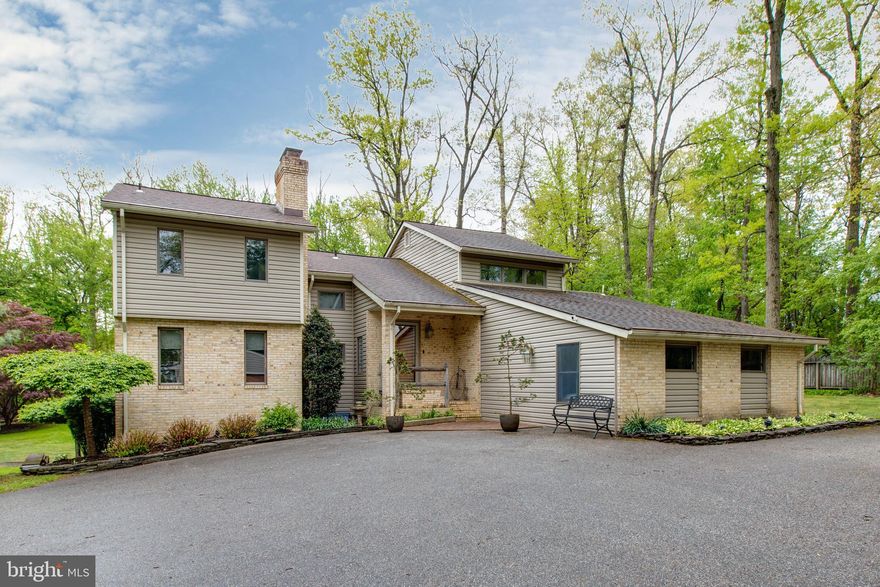 Beautiful custom home on a 1.5  acre  private woodland lot . Features 4BR/3BA with 2 half BA, including a rare MAIN LEVEL IN-LAW SUITE with a private entrance. Enjoy a designer kitchen, hardwood floors, and a spa-like master bath. Major upgrades include a  heating furnace (2024) and water tank (2024). The finished walk-out basement leads to an outdoor oasis with professional hardscaping, a two-tier deck, and multiple patios. Situated in a premier school district minutes from everything. The perfect combination of privacy, style, and convenience!