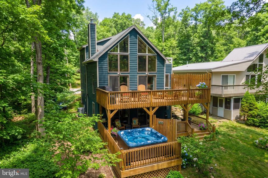 Nestled in a quiet cove along central Deep Creek Lake, this charming 3-bedroom, 3-bath chalet offers the perfect blend of comfort, space, and lakefront living. Recently updated throughout, the home features multiple gathering areas, including a spacious great room with a fireplace, and a lower-level rec space complete with a pool table and bunkroom for additional sleeping area. Expansive decking overlooks a large yard leading to your private dock, creating an ideal setting for enjoying days on the water and peaceful lake views. Outdoor amenities include a hot tub and fire pit area, perfect for unwinding after a day of boating or exploring. Detached garage with additional flex use living space above. With its desirable location and efficient layout, "Lake Effect" presents a strong opportunity as a private retreat or income-producing vacation rental. Call today for details!