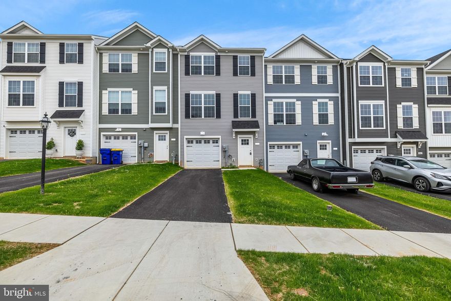 Welcome home to 456 Bradford Dr in Red Lion PA! Located in the Hudson Ridge community within the Dallastown Area School District, this newly constructed interior townhome offers approximately 1,900 square feet of modern living space with quick move-in opportunities available, as well as additional to-be-built options. Designed with a bright, open layout and 9+ foot ceilings throughout, this 4 bedroom, 3.5 bath home combines functionality, natural light and contemporary finishes in a convenient location. The main living level features an open floor plan connecting the kitchen, dining and living areas. The kitchen is equipped with granite countertops, an island, built-in range and microwave, stainless steel appliances including a dishwasher, and upgraded lighting fixtures throughout the kitchen and dining space. Sliding glass doors off the dining area provide access to an optional rear deck, while a conveniently located half bath completes the level. Luxury vinyl plank flooring runs throughout the first and second floors, enhancing the clean and modern design. Upstairs, the spacious primary suite features cathedral ceilings, ceiling fan, large walk-in closet and a private bath with a walk-in shower. Two additional bedrooms with carpet flooring and a shared full bath complete the third floor. The entry level includes a fourth bedroom with an attached full bath, offering flexibility for guests, office space or multigenerational living, along with interior access to the attached one-car garage. Conveniently located near Route 24, Route 74 and I-83, with easy access to York, Baltimore, Red Lion and surrounding commuter areas. Close to shopping, dining and everyday conveniences while offering low-maintenance new construction living. Schedule your private tour today!