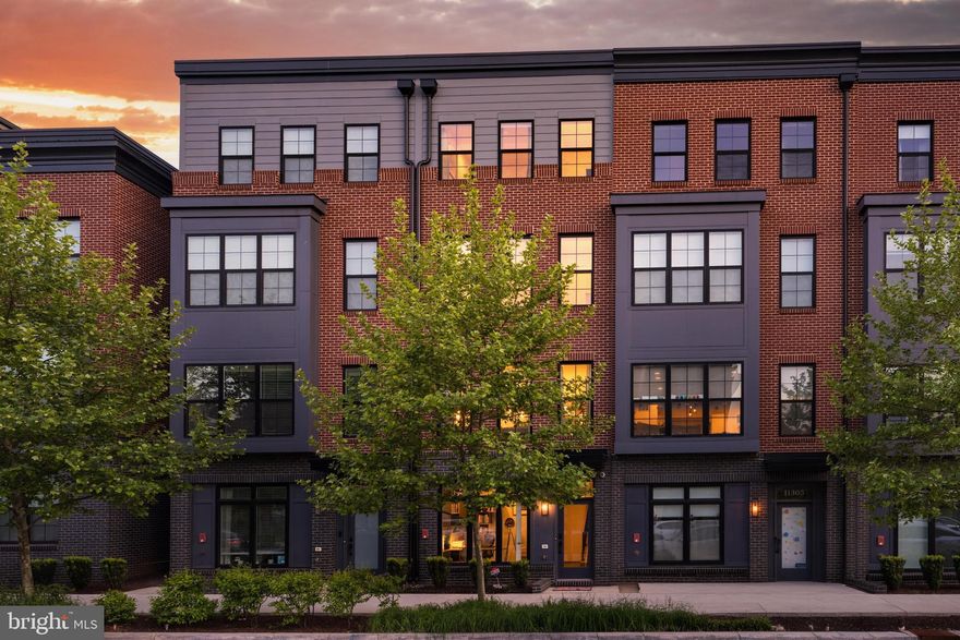 Join us this Saturday, May 2nd, from 1-3pm for an Open House!!

Welcome to 11303 Reston Station Blvd, ideally located in the heart of Reston Station with the Wiehle–Reston East Metro stop just across the street—offering exceptional convenience for commuting and daily living. Enjoy an abundance of shopping, dining, and everyday amenities all within walking distance, plus easy access to the W&OD Trail for outdoor recreation. Major commuter routes including Route 267 and the Fairfax County Parkway are just minutes away.

Built in 2021, this like-new home has been meticulously maintained and offers modern finishes throughout. The entry level features a versatile office space, mudroom, and access to the one-car garage with additional storage.

The main level is designed for both everyday living and entertaining, showcasing an upgraded kitchen with sleek Euro-inspired cabinetry, top-of-the-line appliances, and gas cooking.

Upstairs, the bedroom level offers two spacious en-suite bedrooms along with a conveniently located laundry.

The top level provides exceptional flexibility with a third bedroom and full bath—ideal for guests—plus a bonus recreation room that opens to a private rooftop terrace, perfect for relaxing or entertaining. Enjoy, and welcome home!