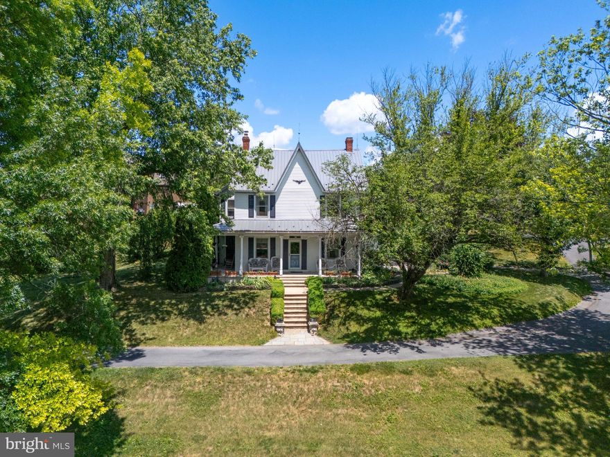 Step into a piece of history with this captivating 4-5 bedroom farmhouse, situated in the highly desirable Northwestern Lehigh School District on 7.4 acres (which includes vacant lot 543947103256 001 with 0.939 acre)! The property boasts a picturesque wrap-around porch, an expansive patio for outdoor gatherings, a quaint summer kitchen, and amenities such as a stable, bank barn, and horse pasture. Adding to its charm, a fenced, thriving orchard graces the landscape with 6 Montmorency Cherry and 2 dwarf pear trees, complemented by a partially wooded lot and a garage for extra storage. Inside the farmhouse, you'll find warmth and character. The 1st floor features an eat-in kitchen complete with Corian countertops, gas cooking and a dishwasher, blending functionality with modern appeal. Convenient 1st-floor laundry facilities enhance practicality, while a spacious dining room, living room plus a large family room provide ample space for entertaining or relaxing. A thoughtfully placed half bath adds convenience for guests. Moving to the 2nd floor, 3 inviting bedrooms and a full bath await, offering comfort and privacy. Ascend further to the 3rd floor, where two generously sized bedrooms provide additional living space or flexibility to suit your needs. Throughout the home, original wide plank floors lend a timeless quality, complemented by charming wood plank ceilings that evoke a sense of heritage and craftsmanship. Large windows throughout flood the rooms with natural light!