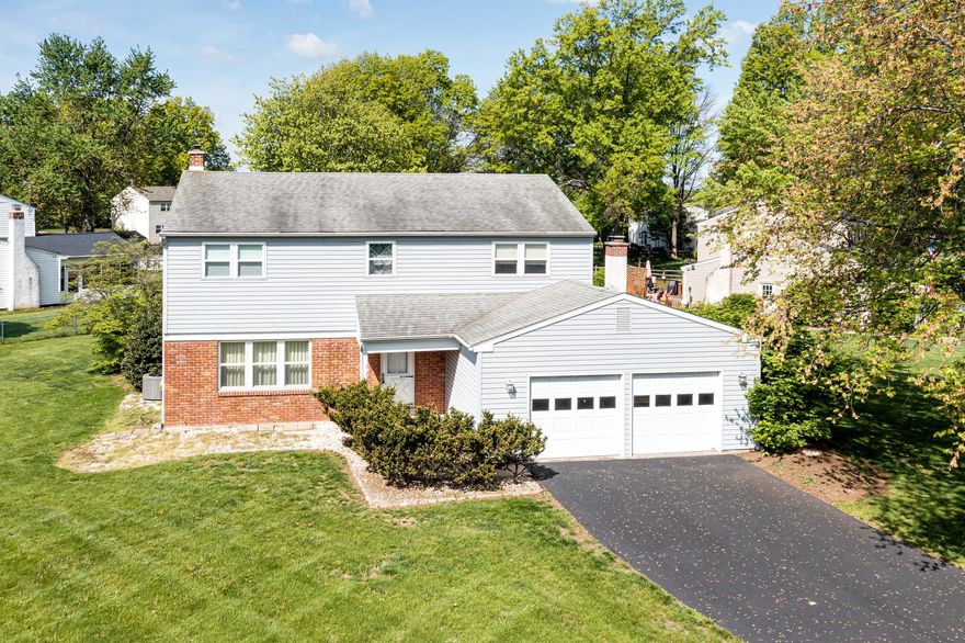 Priced to sell and full of potential, this spacious 4-bedroom, 2.5-bath colonial offers over 2,300 square feet on a desirable corner lot in Lansdale. A classic brick and siding exterior, covered front porch, and long driveway create great curb appeal, complemented by a 2-car front-entry attached garage. Step inside to a welcoming foyer with a well-placed coat closet. The formal living and dining rooms feature crown molding and wall-to-wall carpeting, with the dining room enhanced by chair rail, ideal for entertaining. The eat-in kitchen offers ample cabinet space, electric cooking, a dedicated pantry, and room to customize to your taste like adding an island. Just off the kitchen, the relaxing family room features a brick wood-burning fireplace, recessed lights, and sliding glass doors leading to the backyard making this space perfect for indoor-outdoor living. A convenient powder room, laundry room, and direct garage access complete the first floor. Upstairs, you’ll find four generously sized bedrooms, including a primary suite with a walk-in closet and private en suite bath with tub shower and linen closet. Three additional bedrooms share a hall bathroom, and a whole-house fan adds extra comfort. The unfinished basement includes a French drain and a sump pump/pit, offering excellent potential for future finishing or storage. Outside, the beautiful yard is well-kept and spacious. Additional features include central air (installed May 2022), forced air heat, and electric cooking. Being sold in as-is condition, this home is a fantastic opportunity for buyers looking to bring their vision and add value. With a solid, spacious, and generous layout, great bones, and a prime location, this home won't last long! Be sure to schedule an appointment before it's gone!