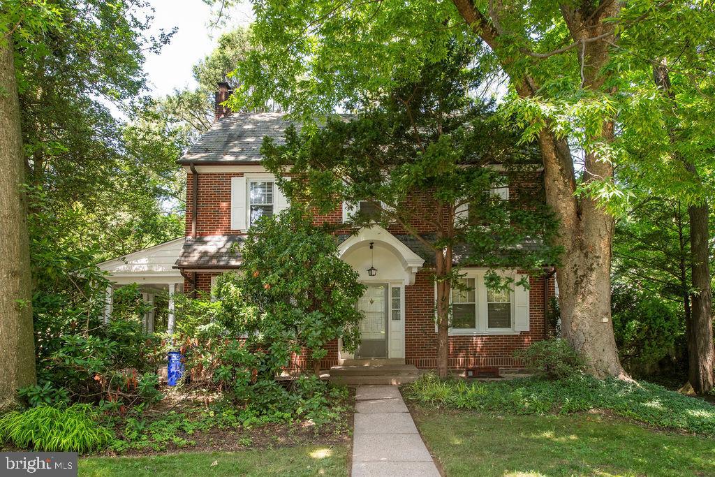 This elegant, red brick Colonial situated on a charming, tree lined street is awash in natural light and awaits your personal touch. To the left as you enter the home, you'll find a spacious living room with a wood burning fireplace framed by two doors that open to a peaceful, covered side porch. To the right there is a dining room that flows into the kitchen that offers a convenient and cozy booth for casual meals, along with an adjacent powder room.. The second floor has three good sized bedrooms and a full bath and the third floor has a fourth bedroom and a sizable walk in attic. There are hardwoods throughout, central air, and there is plenty of parking with a long driveway leading to a detached two car garage. The property backs up to the George Perley Bird Sanctuary and is close to the shops, restaurants, and theaters of both Glenside and Jenkintown. Septa Regional Rail is nearby for an easy ride downtown. Make an appointment to see this special home today.