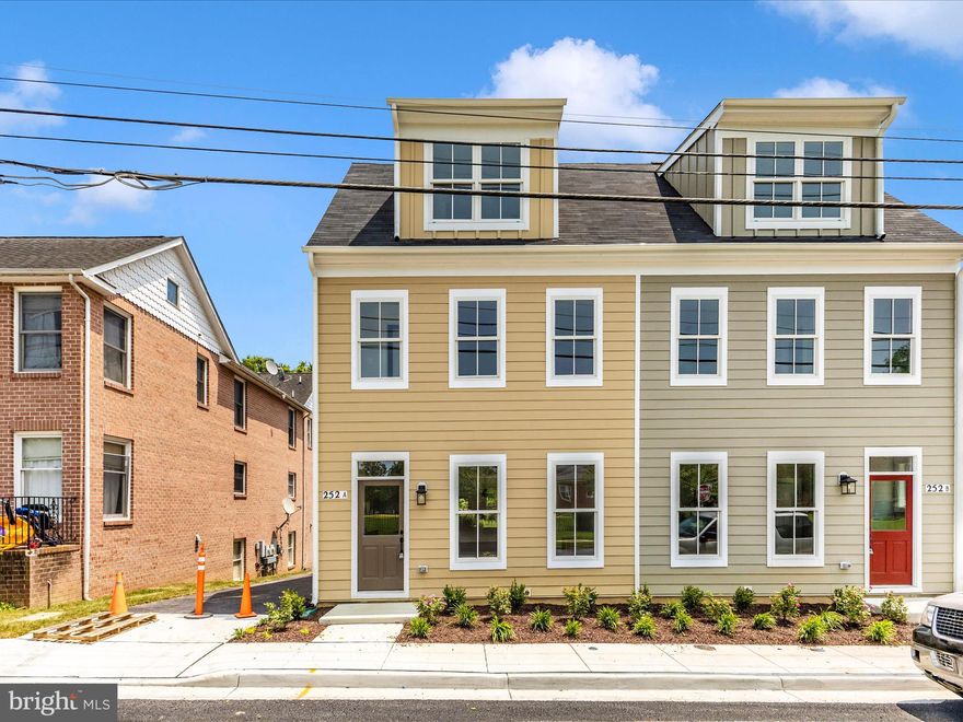 Walk to everything Frederick has to offer including the NEW Whole Foods a block away.  This one is a 100 walk score !!  This property is a versatile 3- or 4-bedroom home boasting stunning views of the city. The main level features soaring ceilings, a cozy gas fireplace, an expansive kitchen island, and numerous upgrades throughout. 
Upstairs, you'll find two primary bedrooms, each with its own full bathroom and walk-in closets. Conveniently, the laundry room is also located on the upper level. 
The third level offers an additional bedroom with a full bath and a spacious gathering room with a mini bar, leading out to a rooftop terrace with breathtaking all-season views. 
The lower level provides extra living space or a 4th bedroom, complete with a full bath. From here, walk up to your fully fenced backyard and elegant Mahogany deck—perfect for outdoor entertaining. 
This home includes ample storage, off-street parking, and a warranty for peace of mind. Don't miss this incredible opportunity!