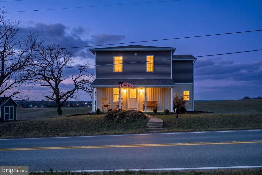 Welcome to this beautifully rebuilt modern farmhouse in New Windsor, where timeless charm meets modern comfort on 1.53 scenic acres. Originally dating back to the 1870s and thoughtfully rebuilt in 2023, this three bedroom, two full and one half bath home offers over 2,050 square feet of light filled living space surrounded by peaceful farmland views.  Use your built in firepit on the patio to watch the amazing sunsets over the farmland!

The open first floor creates an inviting flow between the living room, dining area, and kitchen, perfect for everyday living and entertaining. Enjoy quiet mornings on the welcoming front porch while taking in the surrounding countryside. Upstairs you will find three spacious bedrooms including a private primary suite with walk in closet featuring custom shelving and a beautifully appointed bath with dual vanity and separate shower. A convenient laundry room located on the bedroom level adds everyday functionality.

Major systems have been recently updated including a new hot water heater installed in 2026, offering added peace of mind for the next owner. Located just ten minutes from downtown Westminster shopping and dining, fifteen minutes to Old Westminster Winery, and minutes from scenic walking trails, this property offers the perfect balance of rural tranquility and convenient access to town amenities.