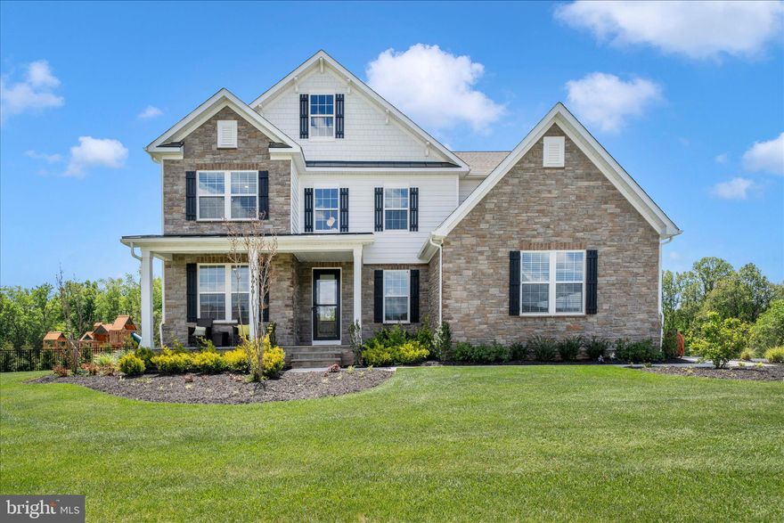 Country meets luxury living on this stunning private homesite offering over 6,000 finished square feet, including a 9-foot finished walkout basement and rare 4-car garage. The elegant Hampton model welcomes you with a grand two-story foyer, formal dining room, tray ceilings, and cozy fireplace.

The chef’s kitchen is designed for entertaining and everyday living, featuring double ovens, stainless steel appliances, a walk-in pantry, and abundant workspace. The finished lower level includes a spacious recreation room, hobby room, and full bath.

Oak stairs with iron balusters lead to the impressive upper level featuring 5 generously sized bedrooms, each with its own bath and walk-in closet. The luxurious primary suite offers a spacious sitting area with tray ceilings and a spa-inspired bath entered through French doors. Enjoy a breathtaking walk-through glass shower with dual shower heads, freestanding soaking tub, separate vanities with quartz countertops, soft-close cabinetry, private water closet, and two oversized walk-in closets.

Additional highlights include Mohawk RevWood flooring in the hallway, bedroom-level laundry room with cabinets and utility sink, and abundant storage throughout with multiple linen closets. This exceptional home combines elegance, comfort, and functionality in every detail.