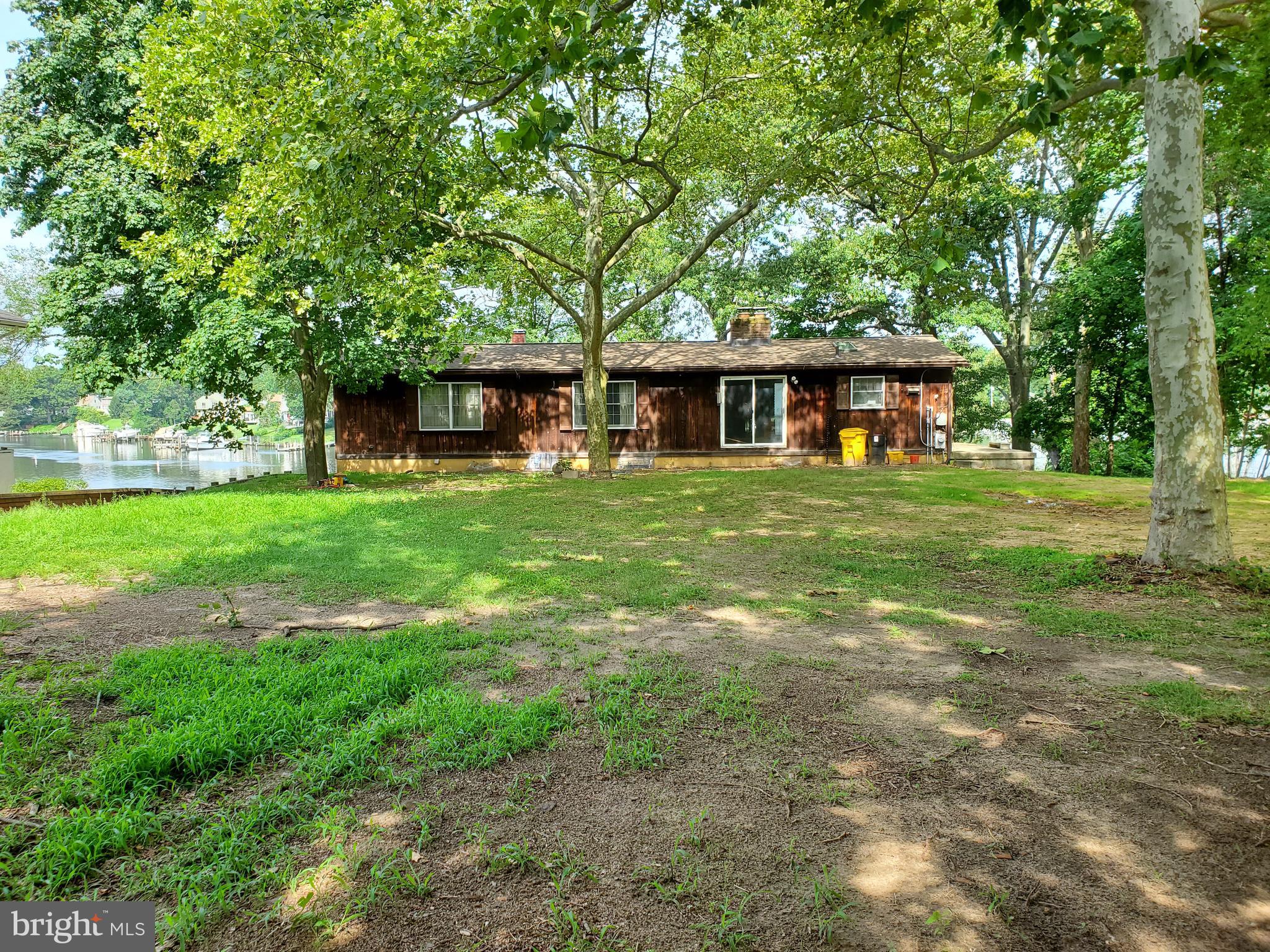 Outstanding 1/2 Ac. waterfront property with over 100 ft of Water frontage . House needs lots of rembodeling but structurally sound and well worth the investment and effort. Raised Rancher is 1 story on road side and 2 story with walkout basement on waterside. New Roof and skylites in September 2019 -2 Fireplaces (one has a pellet stove.) Deep water pier and steps in great shape - 2 car and 1 car garages need work but are grandfathered in - 5 Sliders on first floor and 3 in basement give incredible views -but need to be replaced - Full unfinished basement w/double sided brick Fireplace --- Rehabbed house up the street on a 50 ft lot just sold for $632,000 - Lots of potential for the right Buyer - Permits filed for removal of 2 dead trees (one at waters edge which will really open up the view even more)-Trees to be removed 9/24/2020 Estate Sale, being sold as/is. Has Public Water - Septic work being done and will be certified. Inground liner pool has been filled in.