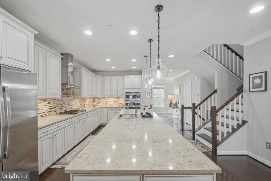 Bespoke Luxury Meets Premier Pikesville Living at 4 Wedge Way
Welcome to an unparalleled lifestyle in the gated Suburban Green subdivision of Baltimore County. Ideally situated in Pikesville, this home offers incredible proximity to local landmarks like the Suburban Club and Woodholme Country Club, as well as the premier retail and dining destinations at Quarry Lake at Greenspring. Enjoy peace of mind in a gated community that provides two access fobs and remains open until 7:00 PM daily for easy guest access. For a truly low-maintenance lifestyle, the condo association fee conveniently covers both water and lawn care.

This residence has been thoughtfully upgraded and highly customized for the most discerning buyer. The sellers incorporated a premium ten-foot extension, significantly expanding the entire footprint of the home. Elegance is found in every detail, from the extensive crown molding and premium custom drapery to the luxury plank vinyl hardwood floors in the fully finished basement.

The gourmet kitchen is a masterpiece of design and function, complete with a custom tile backsplash, convection wall and microwave ovens, and brilliant under-cabinet task lighting featuring dimmers and seamlessly hidden appliance outlets. The adjoining family room centers around a beautiful gas fireplace, thoughtfully pre-wired with an HDMI connection to discreetly house your media boxes below the hearth. Dimmer switches and recessed lighting elevate the ambiance throughout the common areas.

The primary suite is an absolute showstopper, boasting an extensively redesigned his-and-hers walk-in closet system with upgraded lighting and a unique bonus crawlspace. Its spa-like en-suite bathroom features a double vanity, a private water closet, and a massive walk-in shower with a built-in bench and dual showerheads. The dedicated laundry area with custom cabinets is perfectly positioned on the living level.

Modern smart-home convenience is integrated seamlessly throughout the property. The home includes a tankless water heater, a whole-house sprinkler system, and a hardwired cable network spanning all bedrooms, the living room, and the basement. Motion-sensor lighting adds effortless utility to the first-floor powder room, pantry, basement bathroom, storage rooms, and exits. Even the two-car garage is a fully finished, customized space, complete with paint, custom cabinetry, a utility sink, two ceiling fans, and an app-controlled garage door.

Make this unparalleled Pikesville dream home yours today!